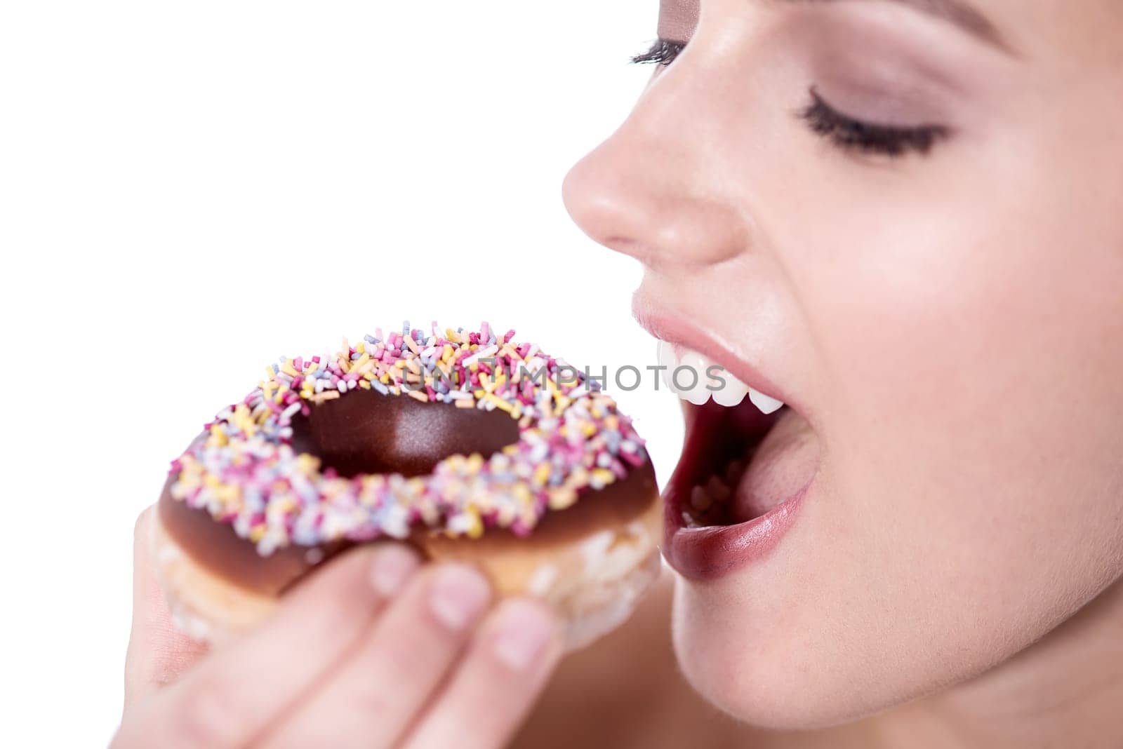 Cropped image of a woman about to eat a donut over white