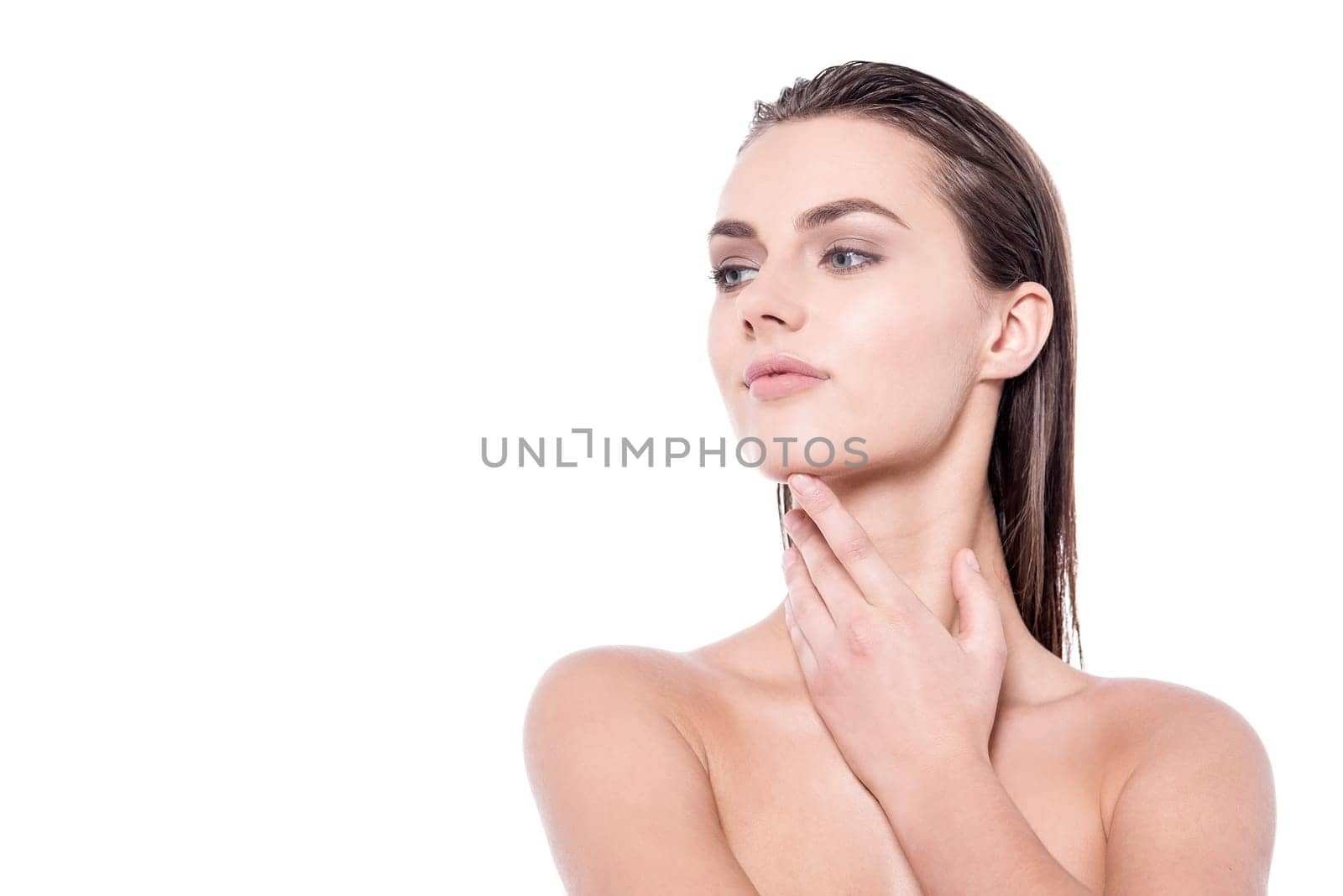 Young topless woman against white background