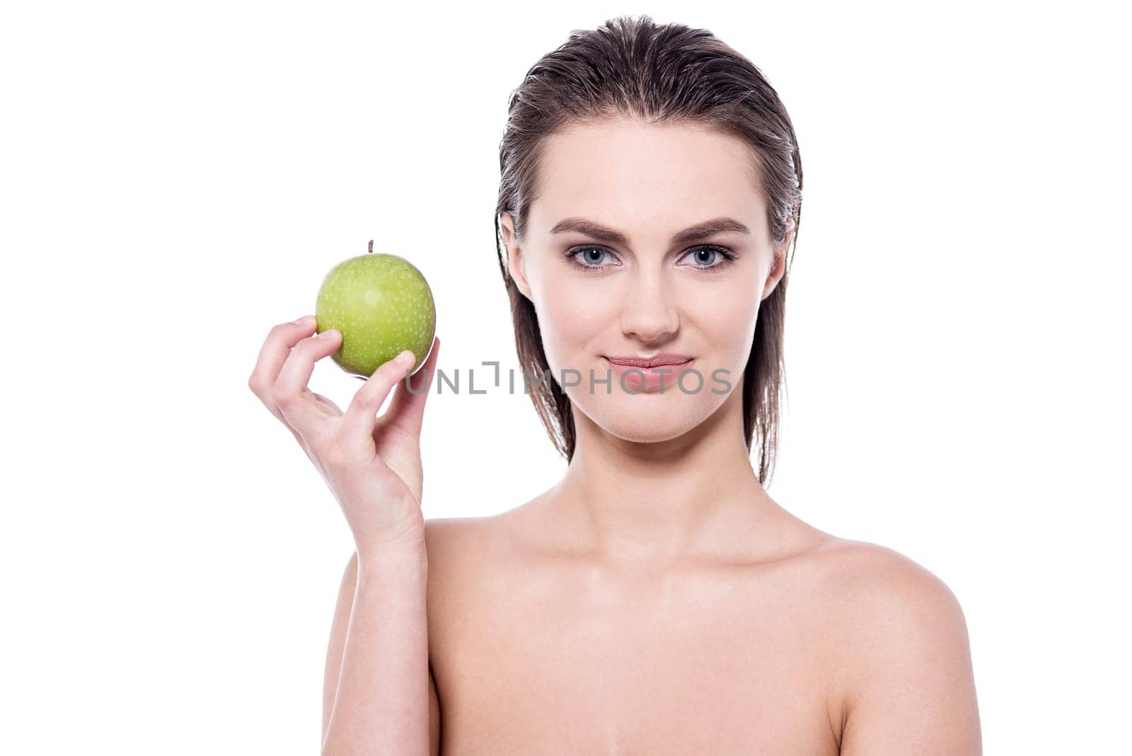 Young woman showing an apple to camera
