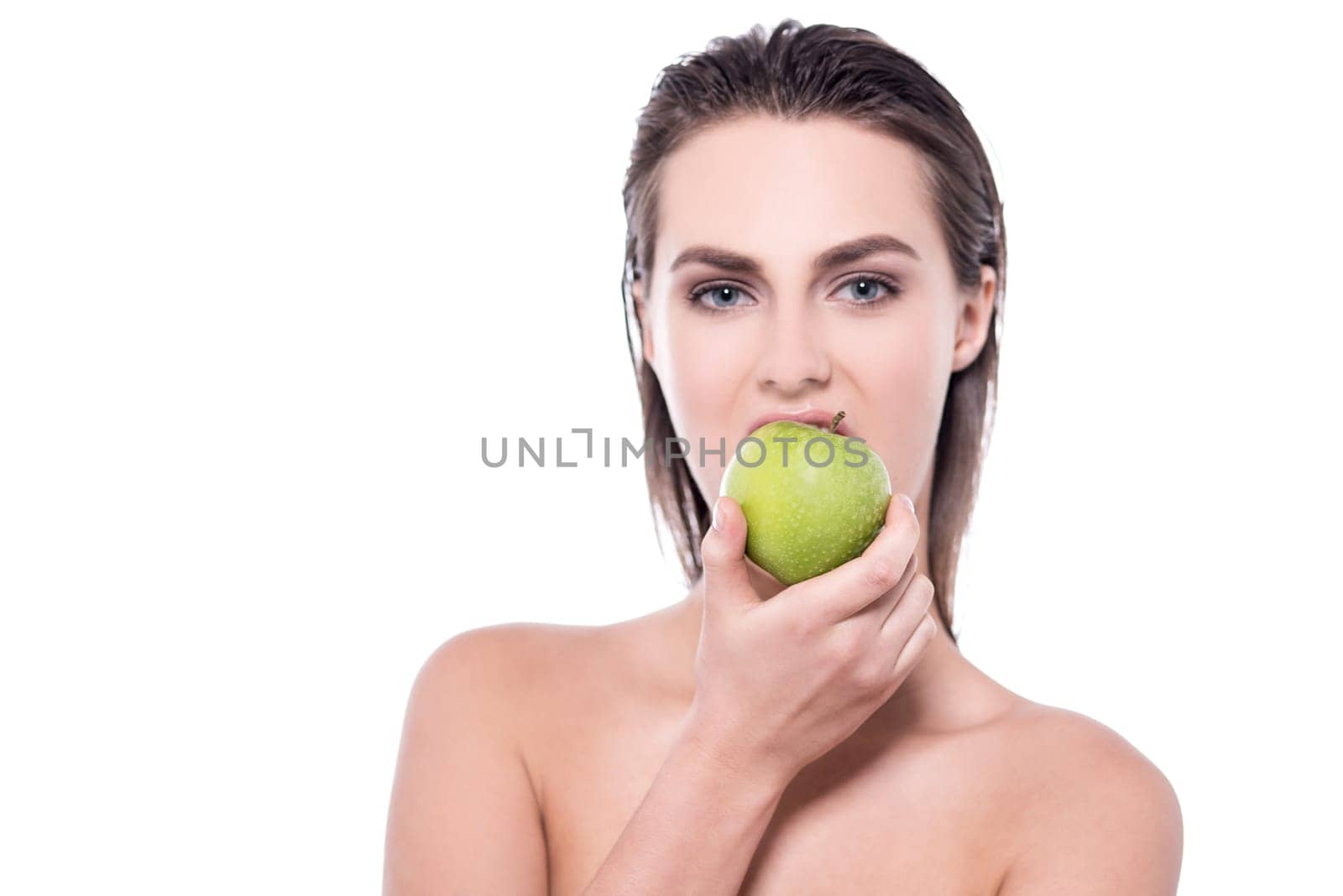 Young woman posing to camera with an apple in her hand