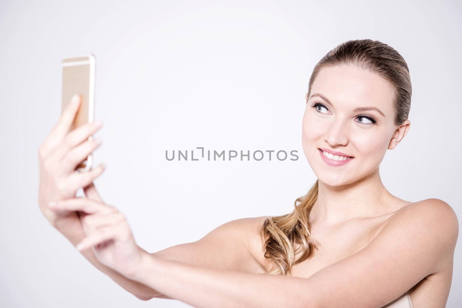 Topless female model clicking her picture