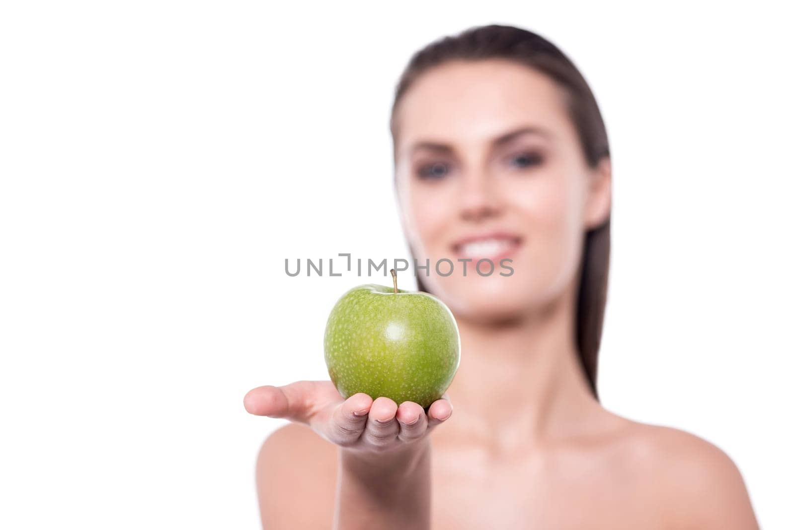 Young woman giving an apple to camera
