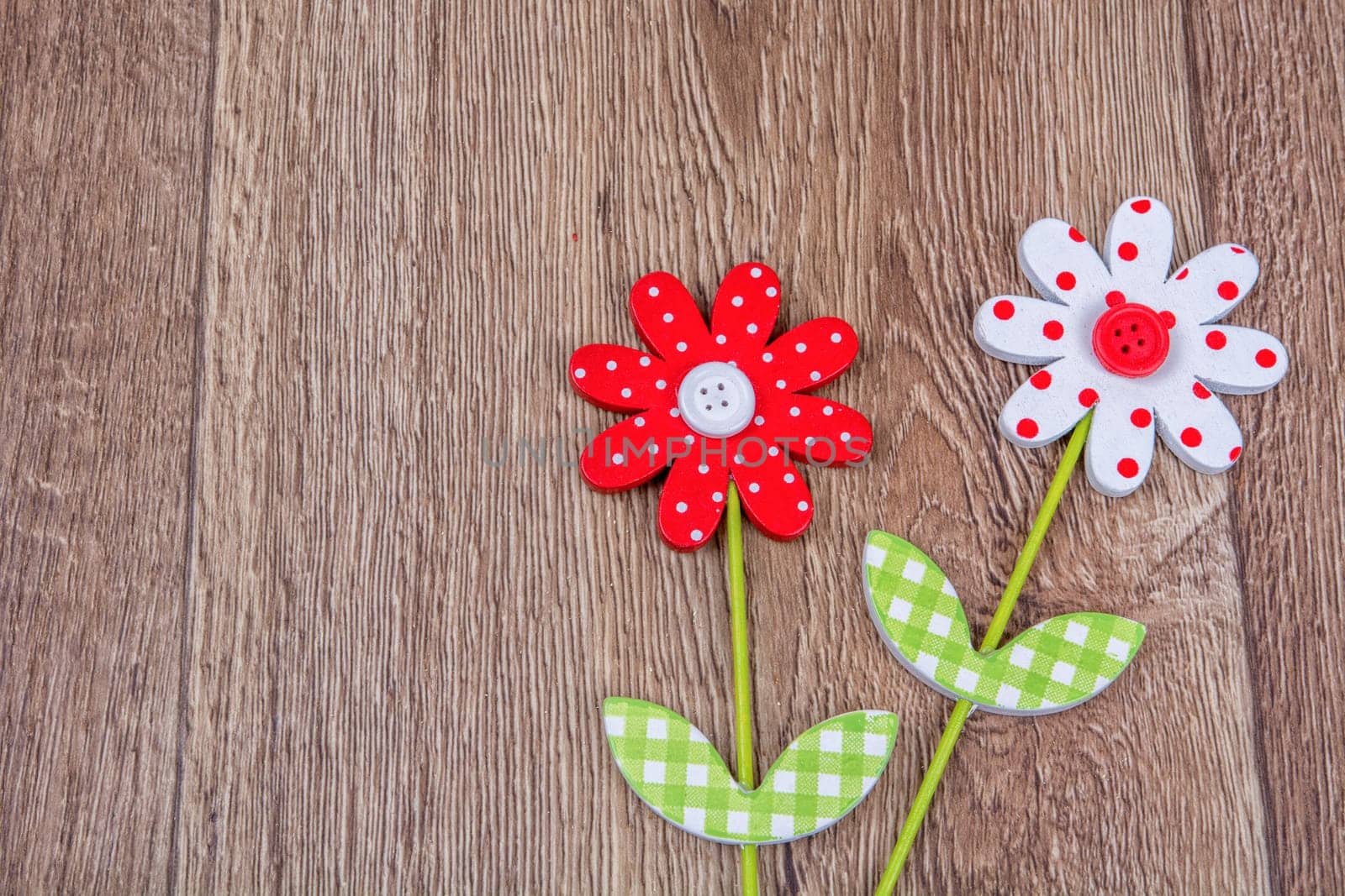 Creative handmade flowers on a brown wooden background