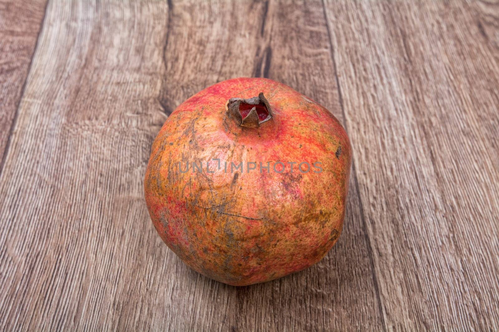 Pomegranate on a brown wooden background