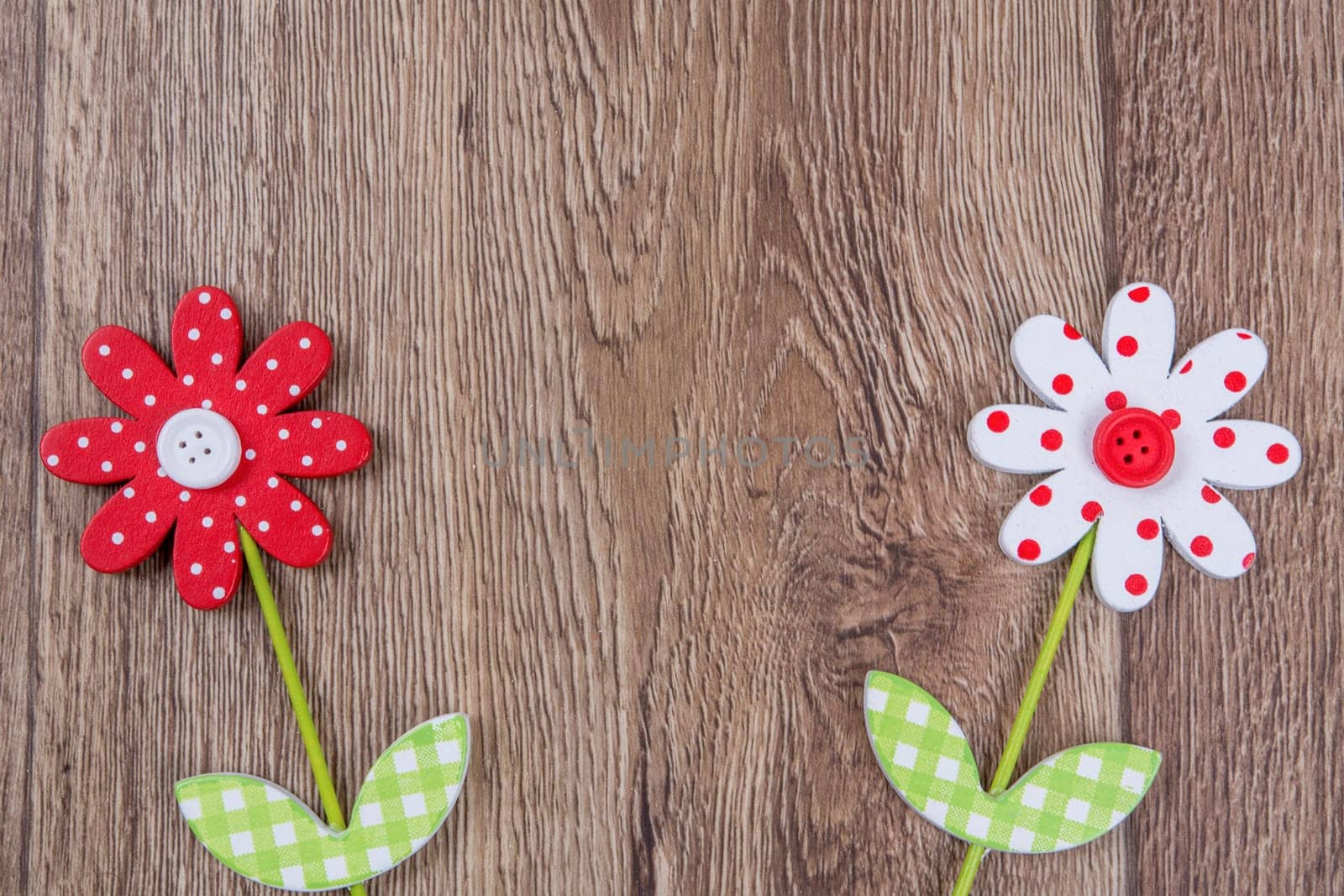 Creative handmade flowers on a brown wooden background