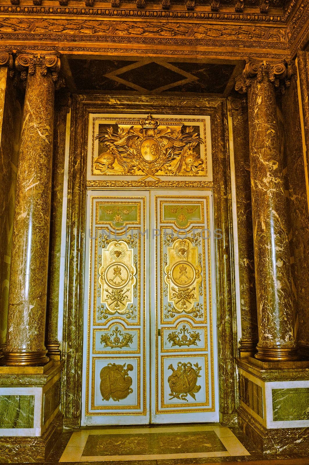 a monumental gate of the castle of Versailles