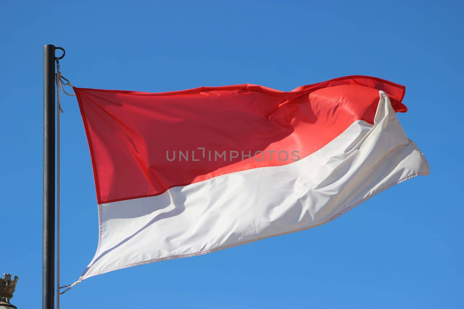 Monaco Waving Flag Against Blue Sky .
