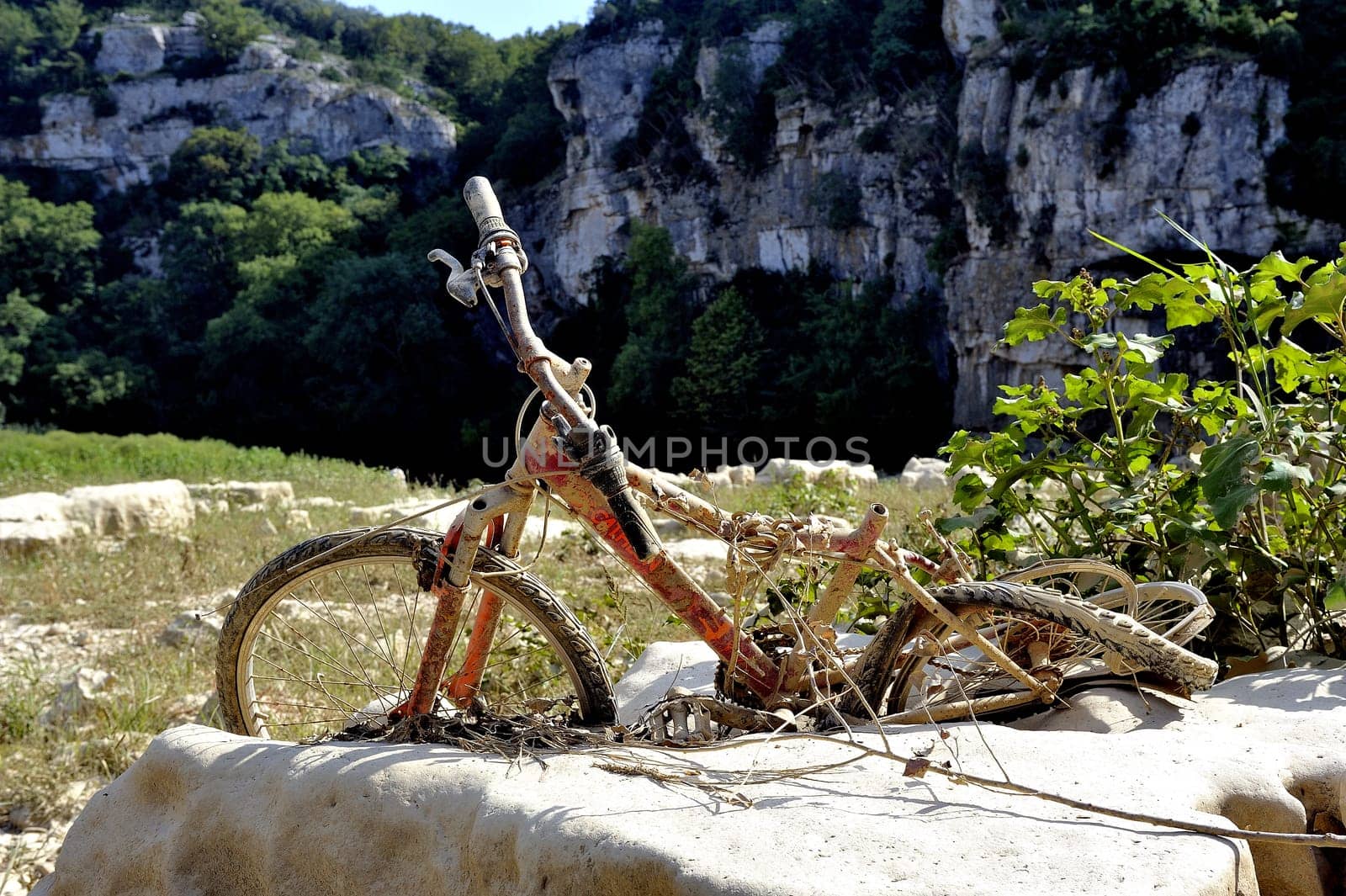 Bike carried away by the water and seen the bed of the river Gardon completely dry during the summer in the French department of Gard in the south-east