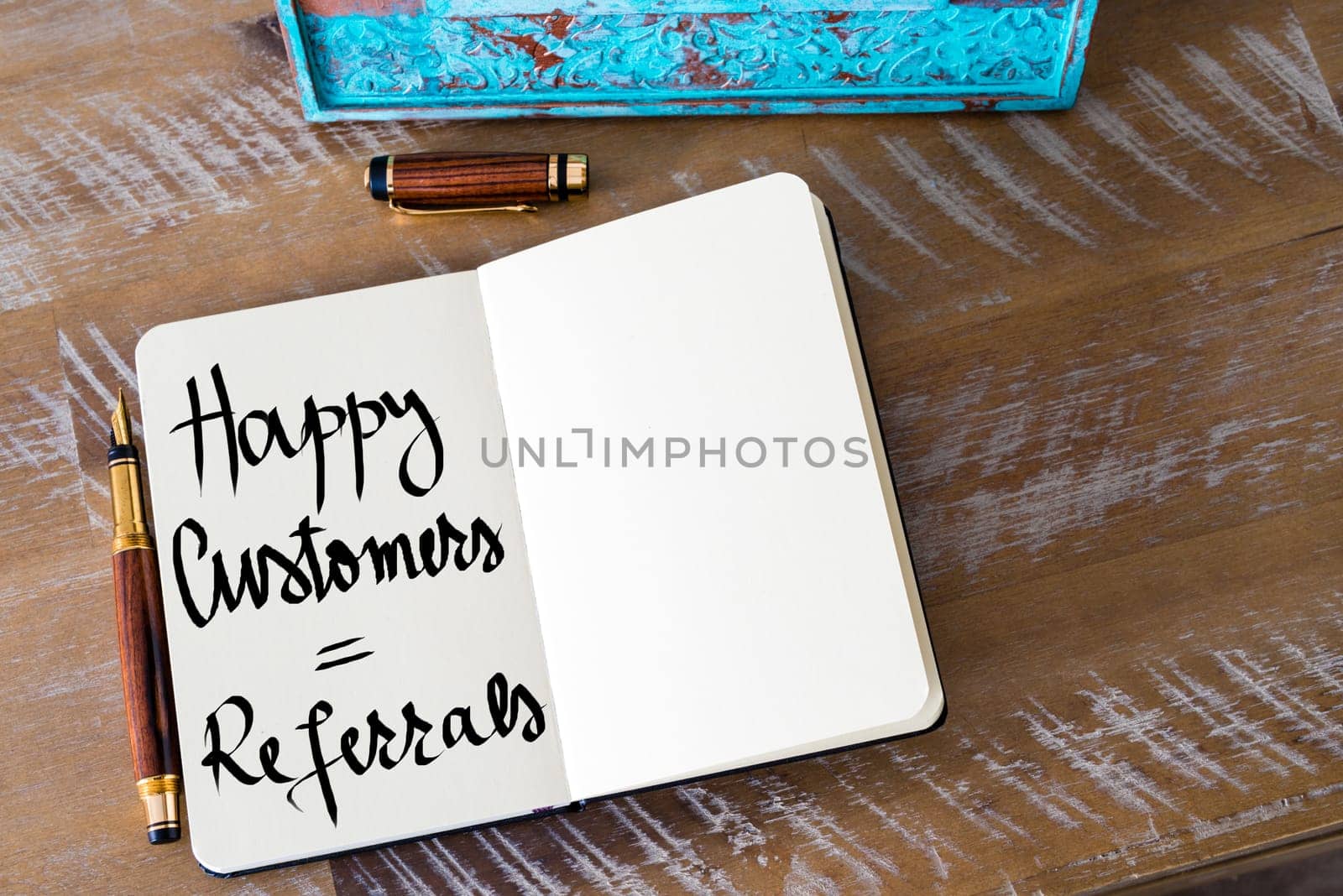 Retro effect and toned image of a woman hand writing a note with a fountain pen on a notebook. Handwritten text Happy Customers equal Referrals as business concept image