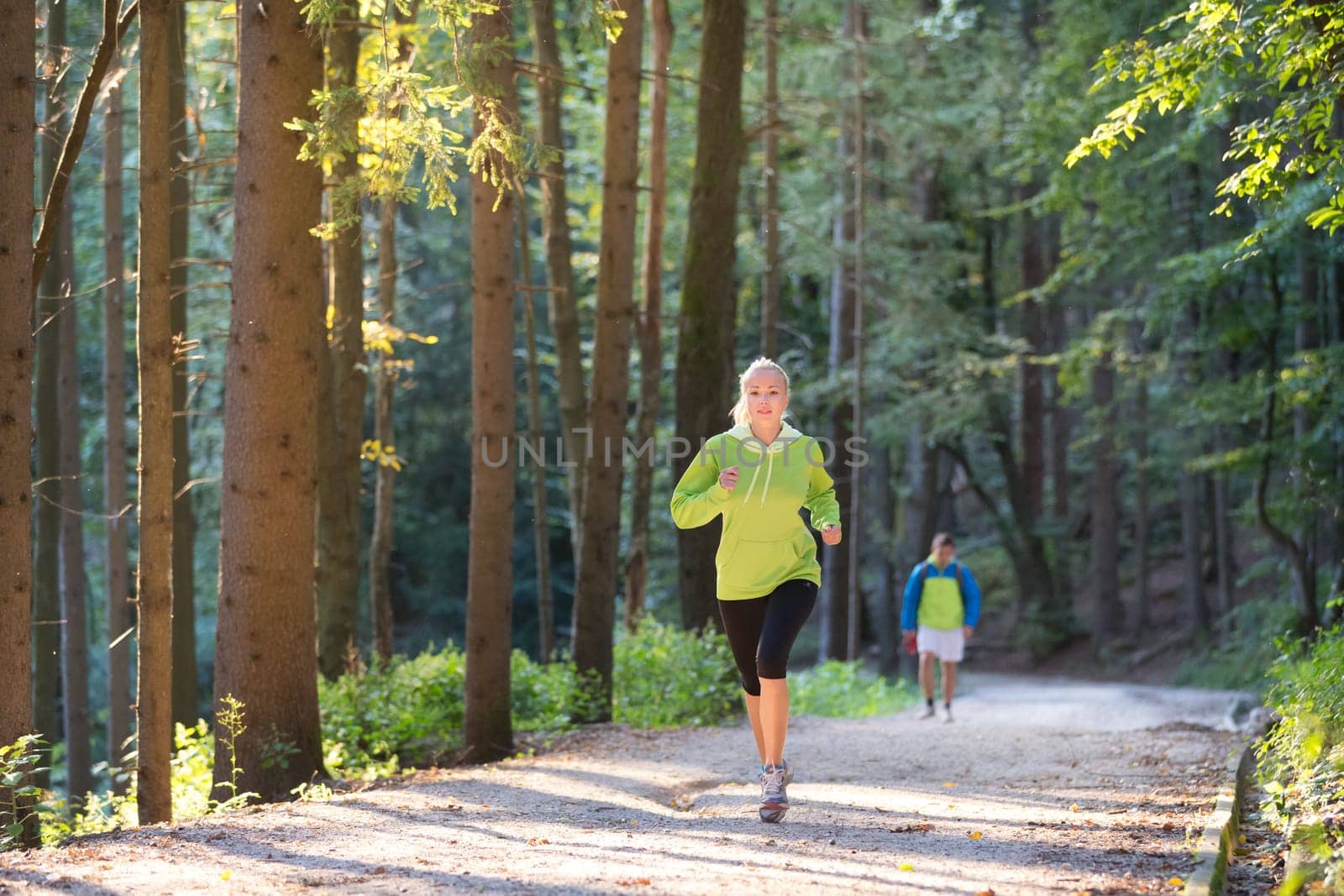 Pretty young girl runner in the forest.  Running woman. Female Runner Jogging during Outdoor Workout in a Nature. Beautiful fit Girl. Fitness model outdoors. Weight Loss. Healthy lifestyle.