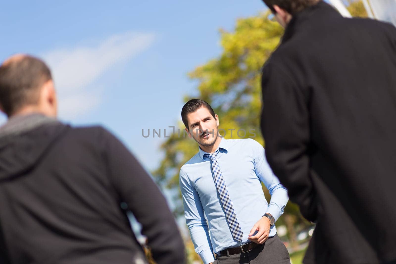 Businessman being approached and blackmailed by two racketeers.