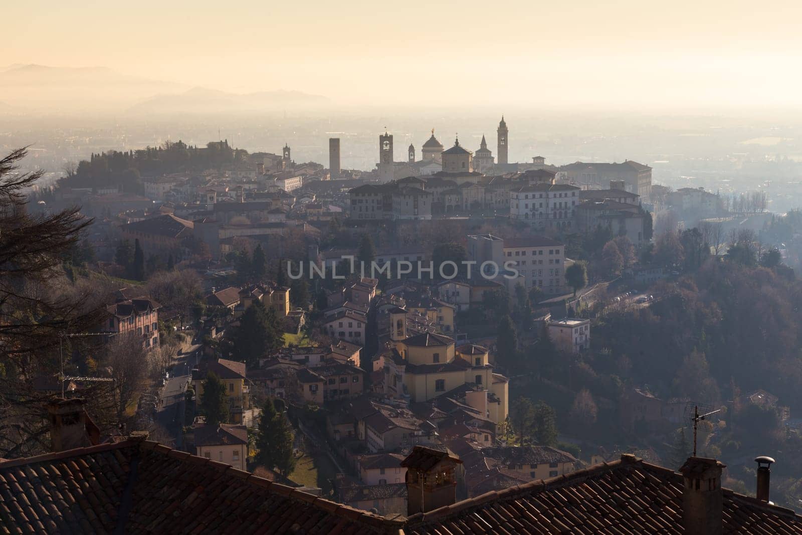 View over Old Town buildings in the ancient city of Bergamo, Lombardia, Italy on a misty winter day, taken from San Virgilio point.