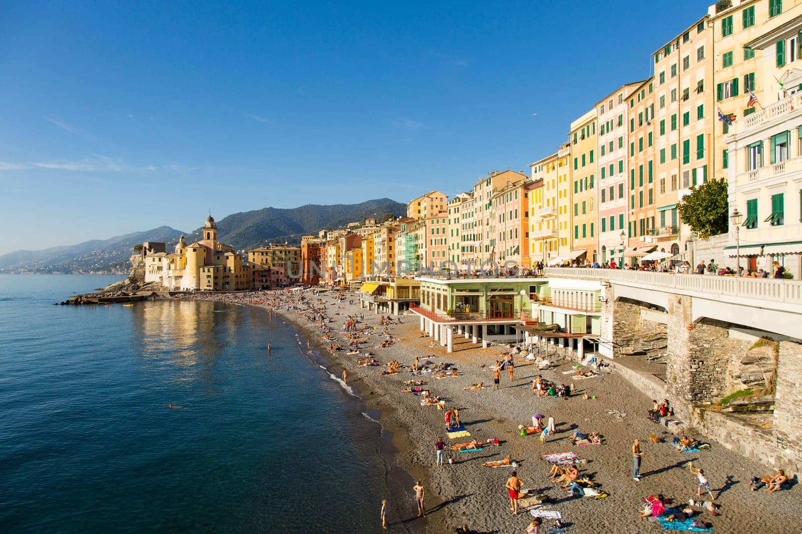 Panoramic view of a seaside town in the foreground beach an church in the background on a sunny day