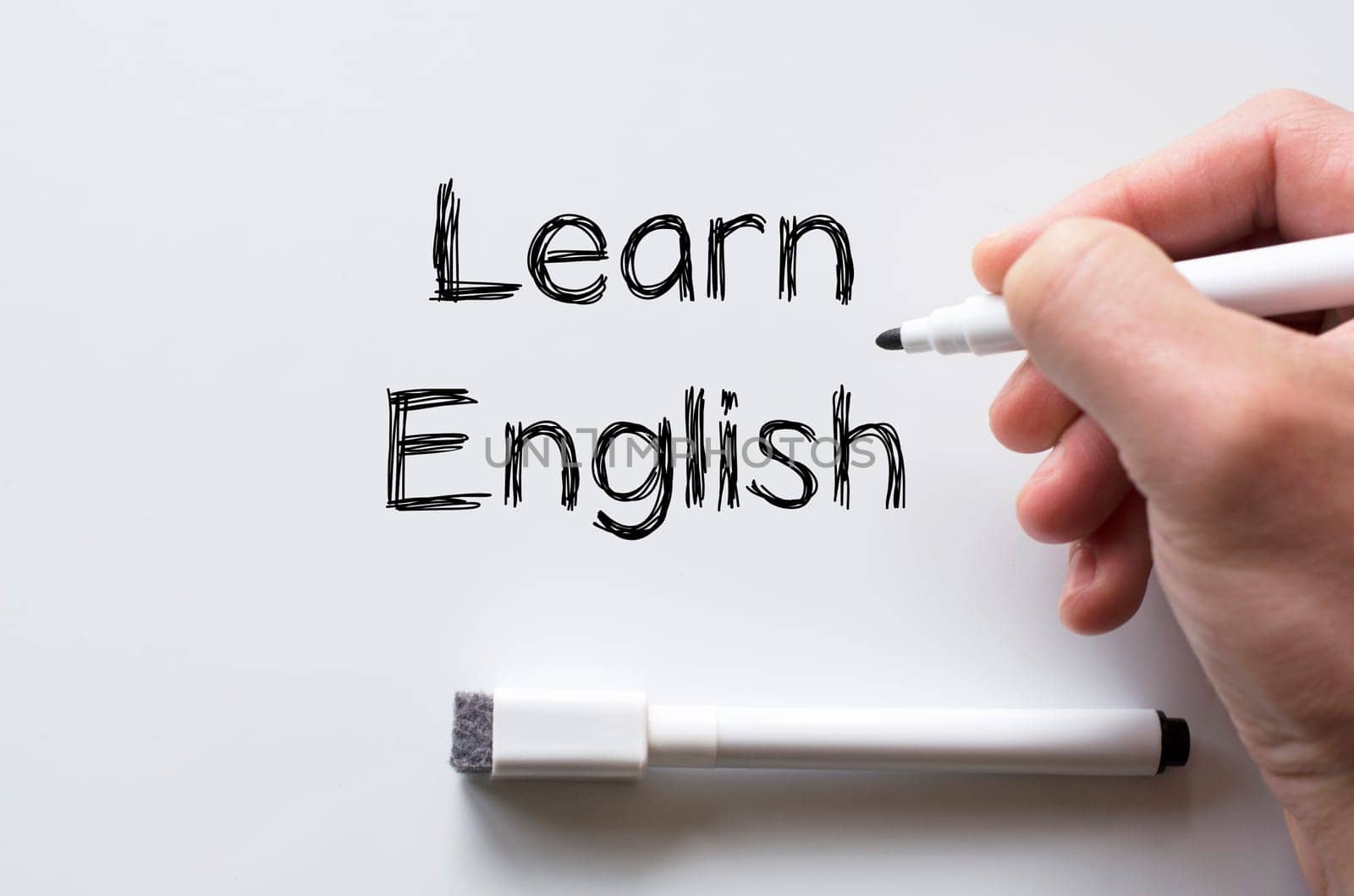 Human hand writing learn english on whiteboard