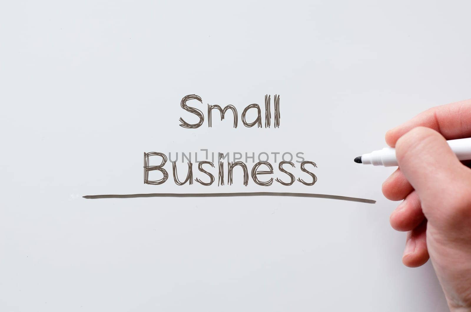 Human hand writing small business on whiteboard