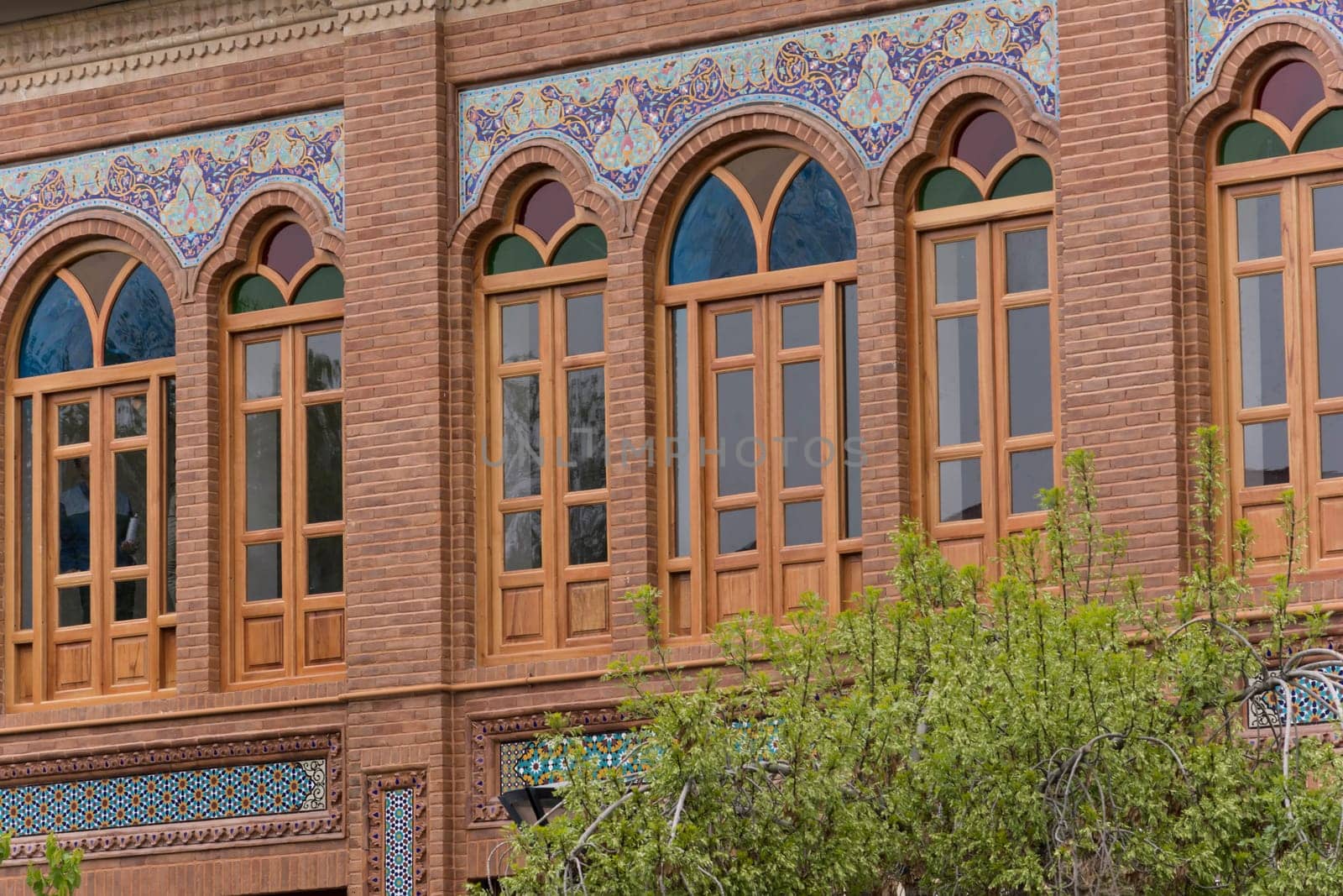 Tehran Province- IRAN-March 17  2016 Building Wooden Windows With Colorful Glasses and Decorated (hand painted) Terracotta Tiles Beside Urban Street.