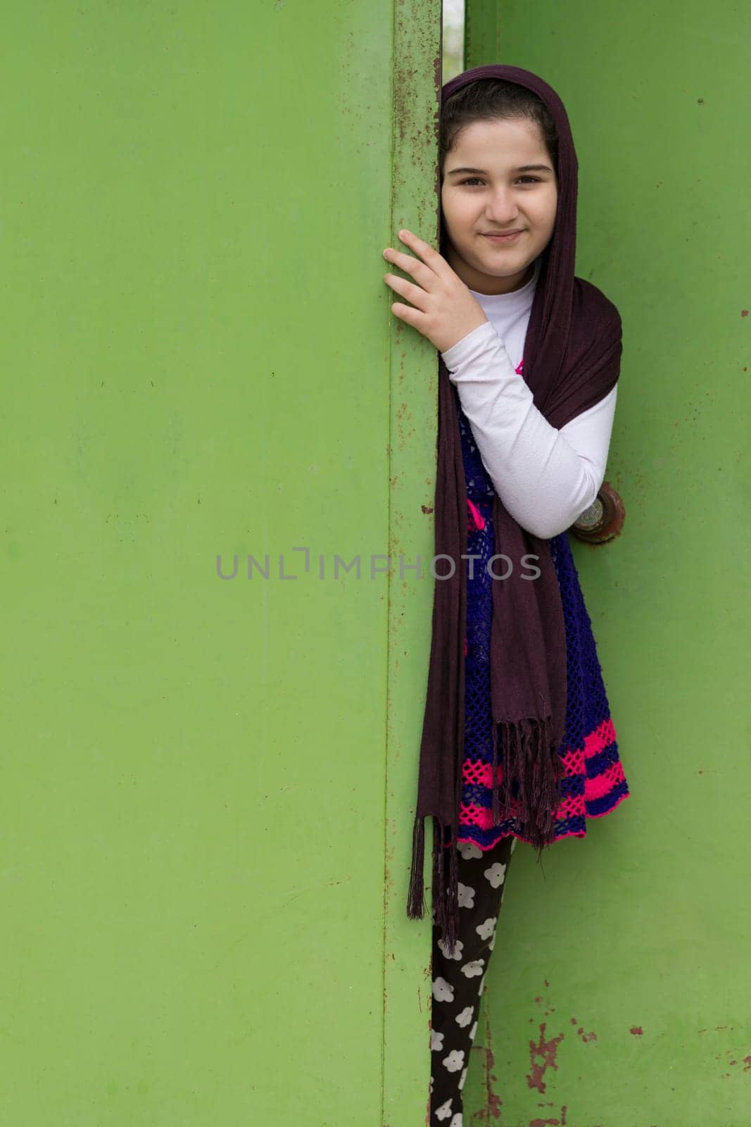 Portrait of a Beautiful Muslim Girl In Front of a Doorway