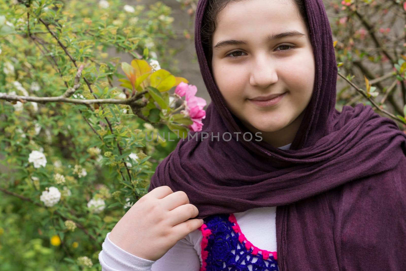 Portrait of a Beautiful Teenage Girl Outdoor in A Garden Viewing Directly to the Camera