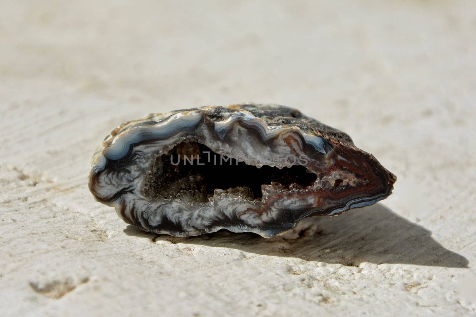 Druse Geode Agate Stone on White Wall in Sunlight