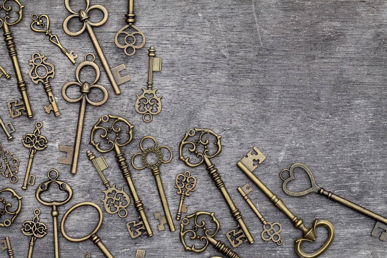 antique rusty key on grunge wooden background