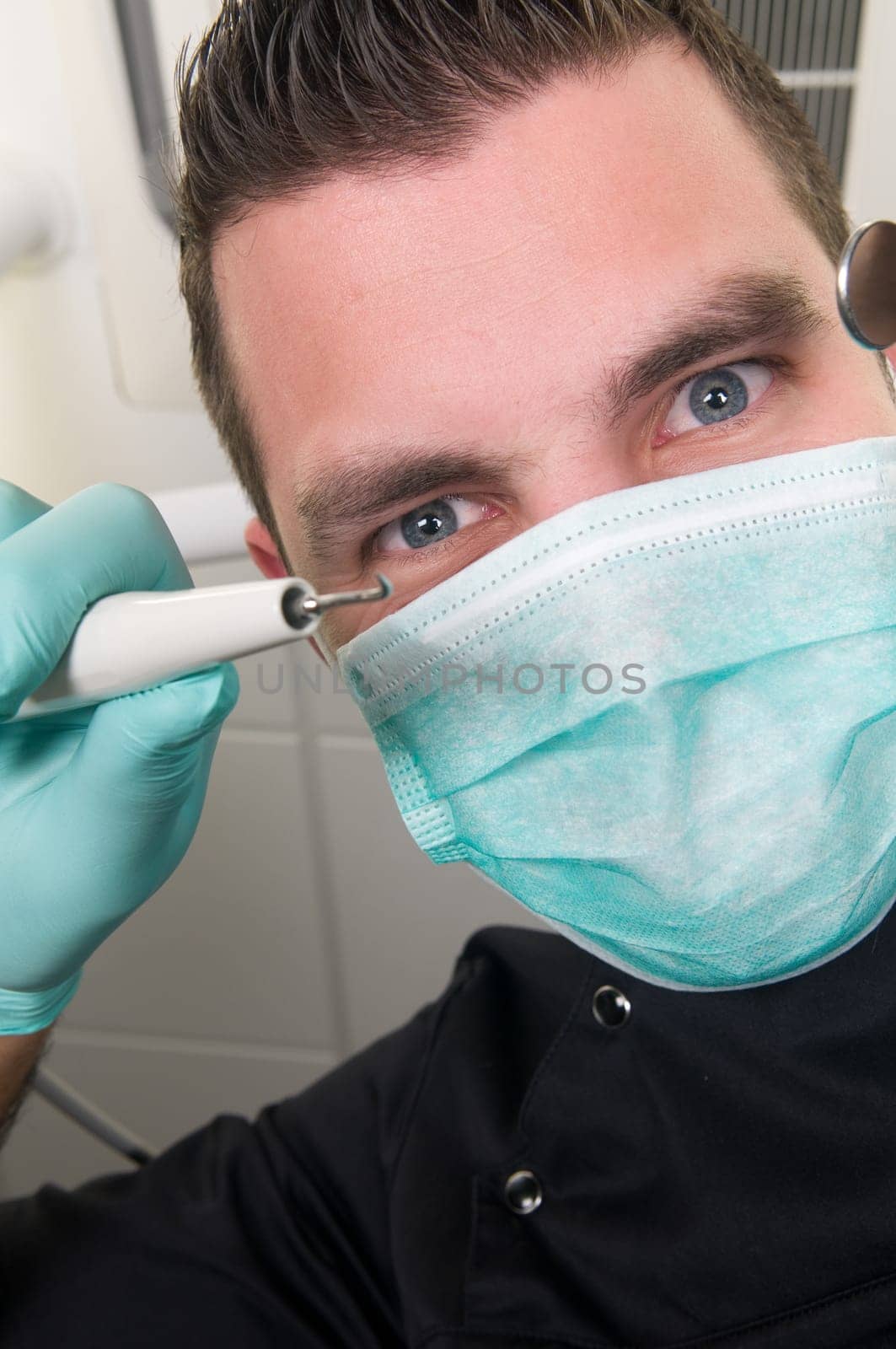 Picture of the dentist, as seen from the patient's point of view, lying in the chair