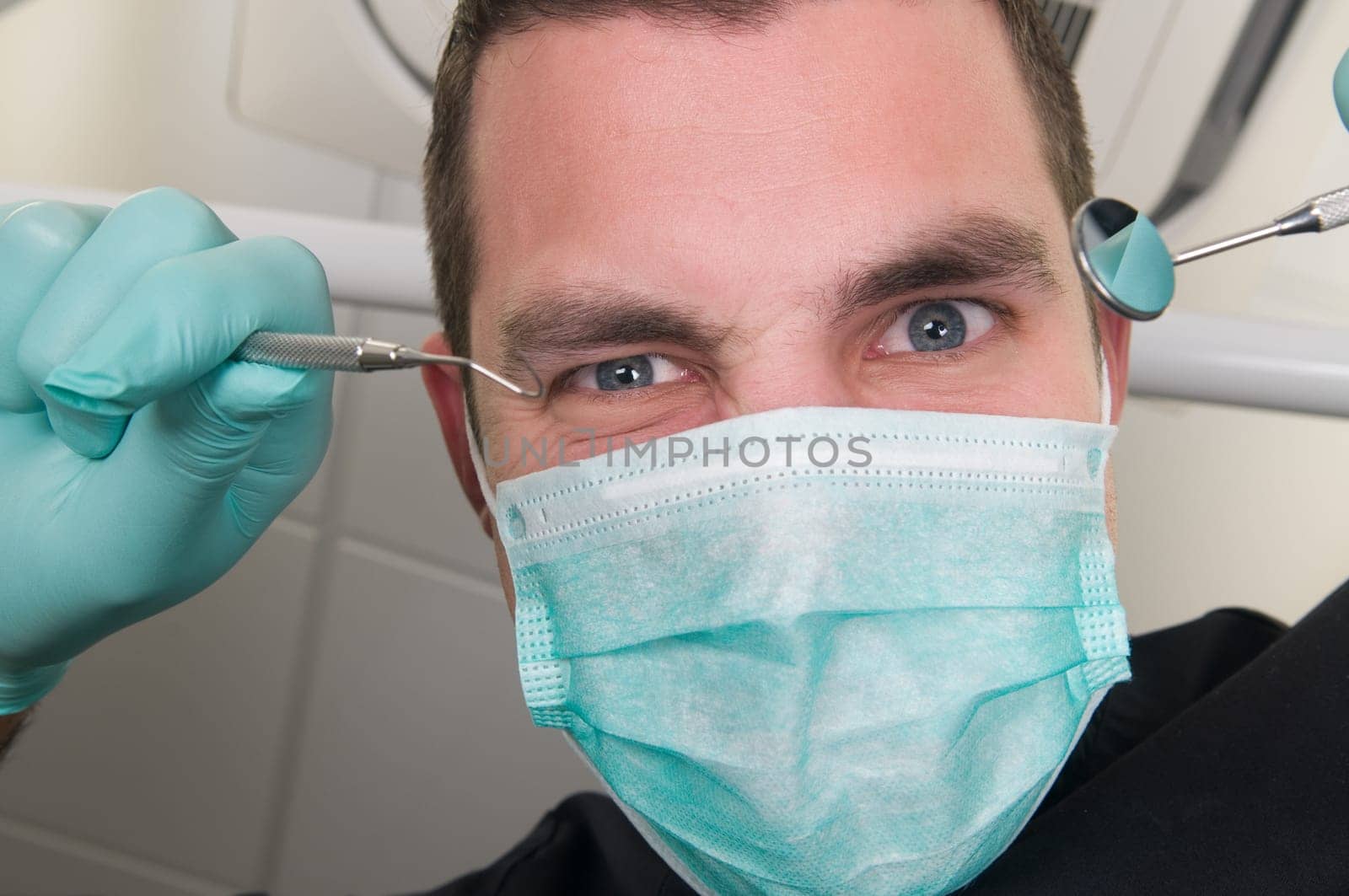 Picture of the dentist, as seen from the patient's point of view, lying in the chair