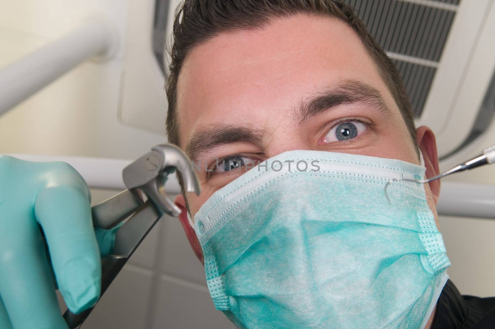 Picture of the dentist, as seen from the patient's point of view, lying in the chair