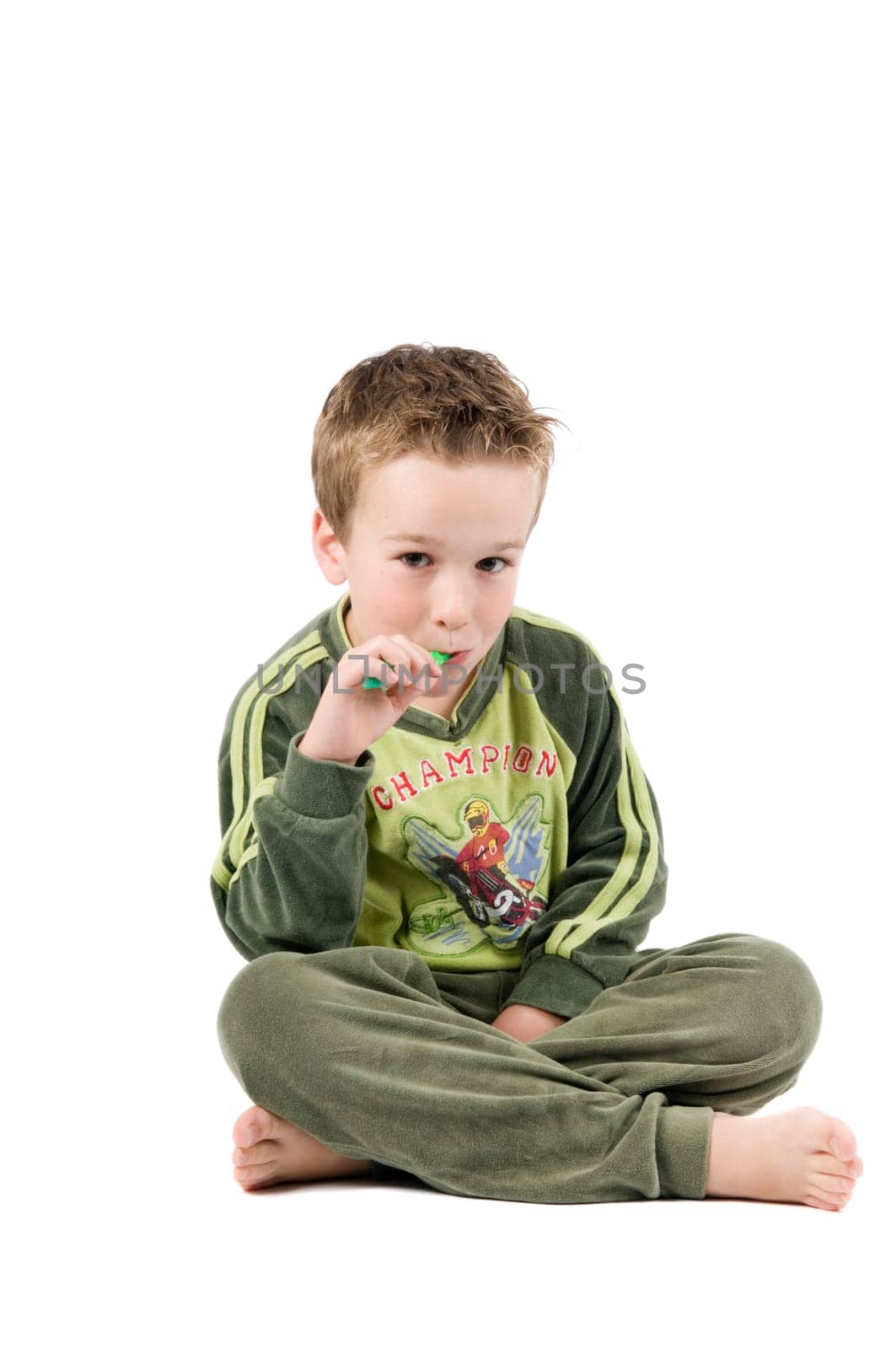 Studiopicture of a child who is going to brush his teeth, isolated on white.