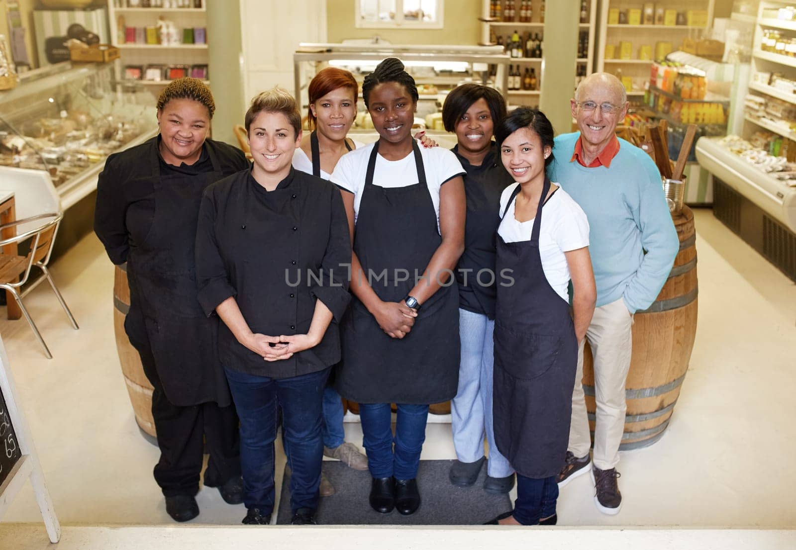 A group of deli workers standing in their shop