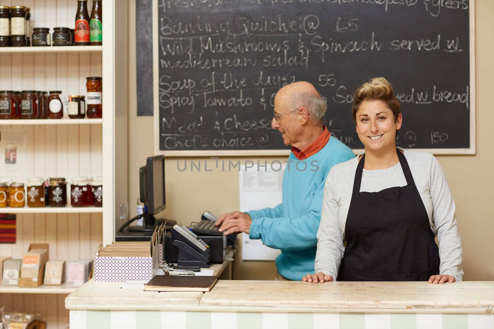 Two small business owners behind the deli counter