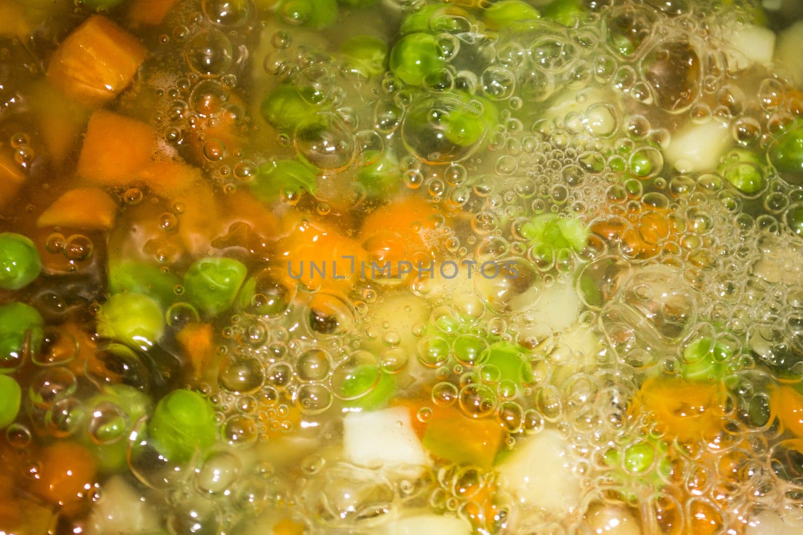 Closeup of cooking various vegetables. Lots of bubles are visible