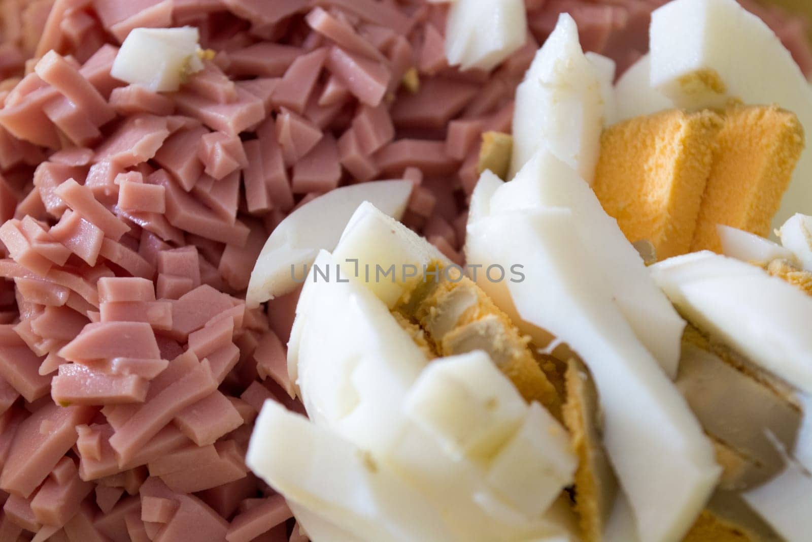 Closeup of ingredients for russian salad. Salami and eggs