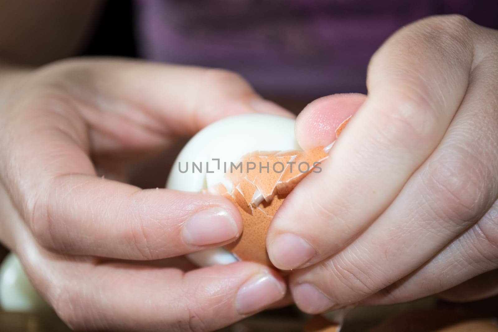CLoseup of hands cleaning boiled eggs