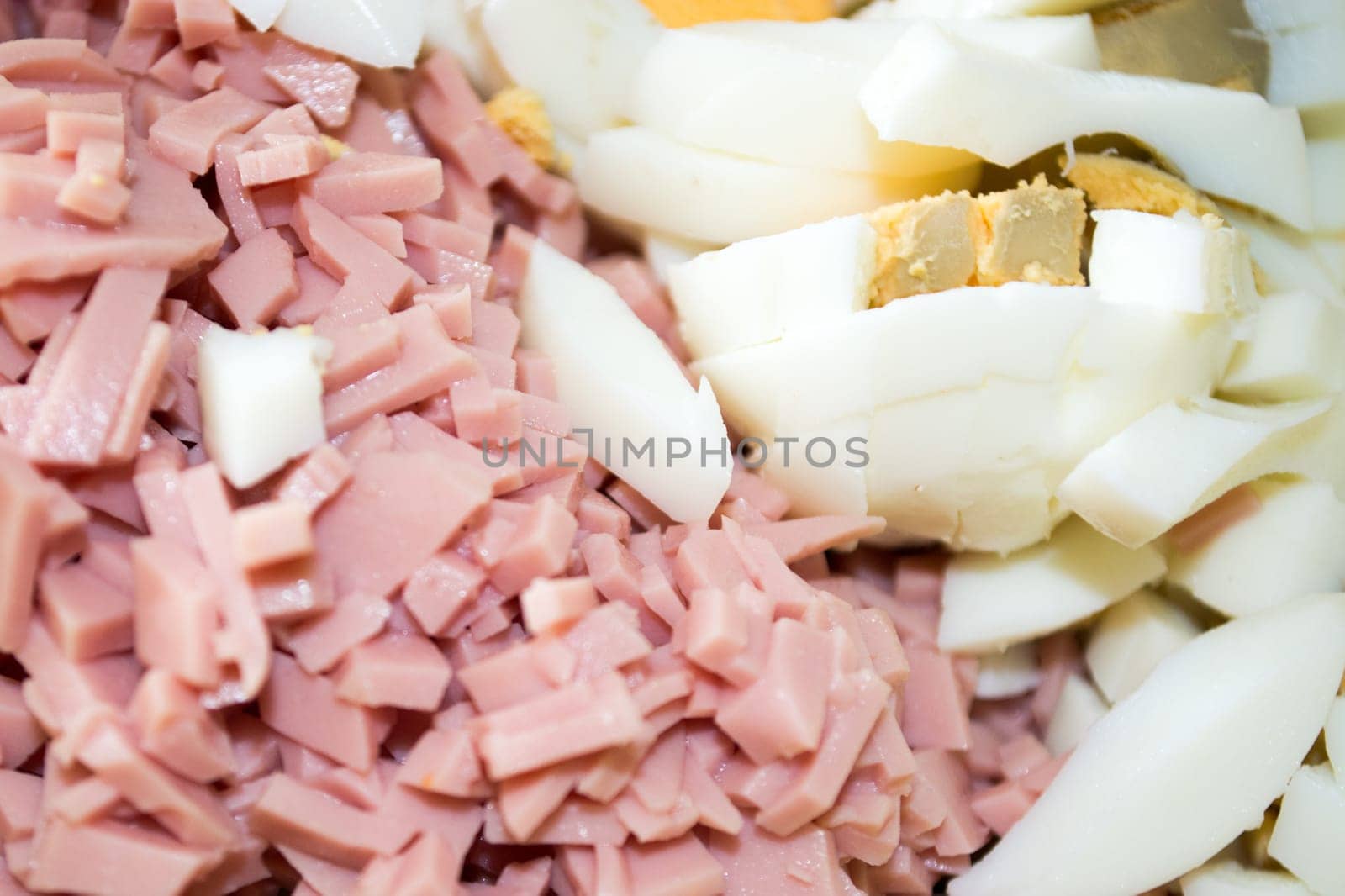Closeup of ingredients for russian salad. Salami and eggs