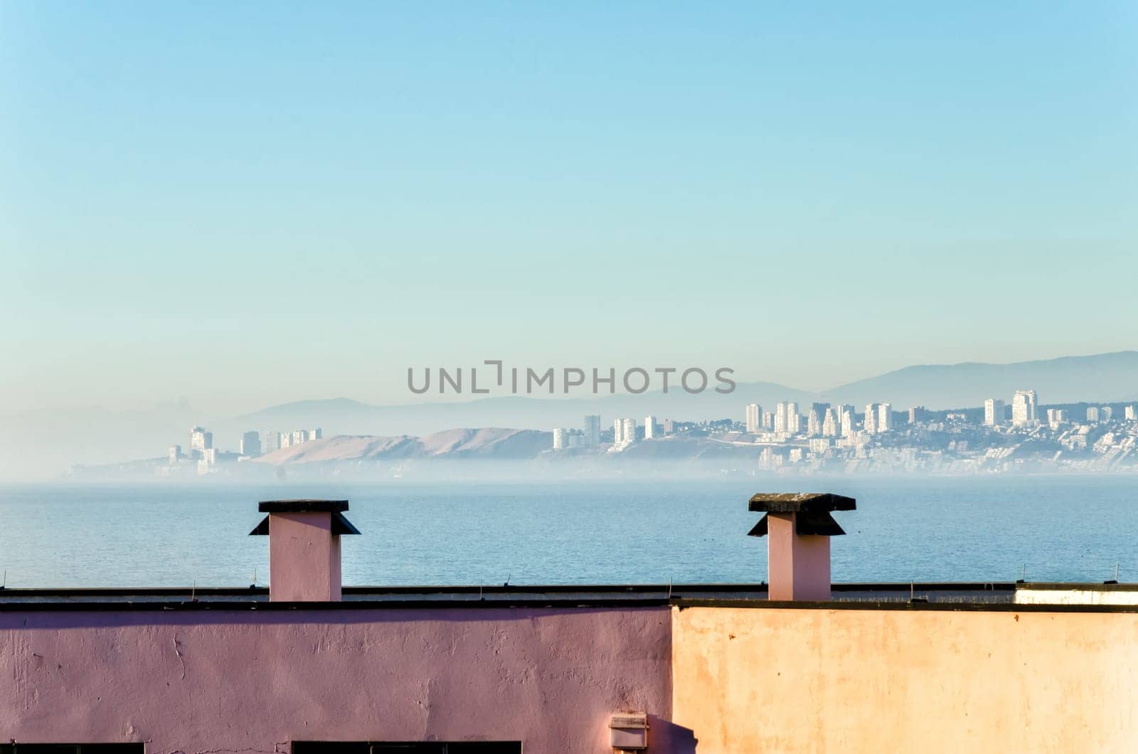 Rooftops in Valparaiso, Chile with Vina del Mar visible in the distance