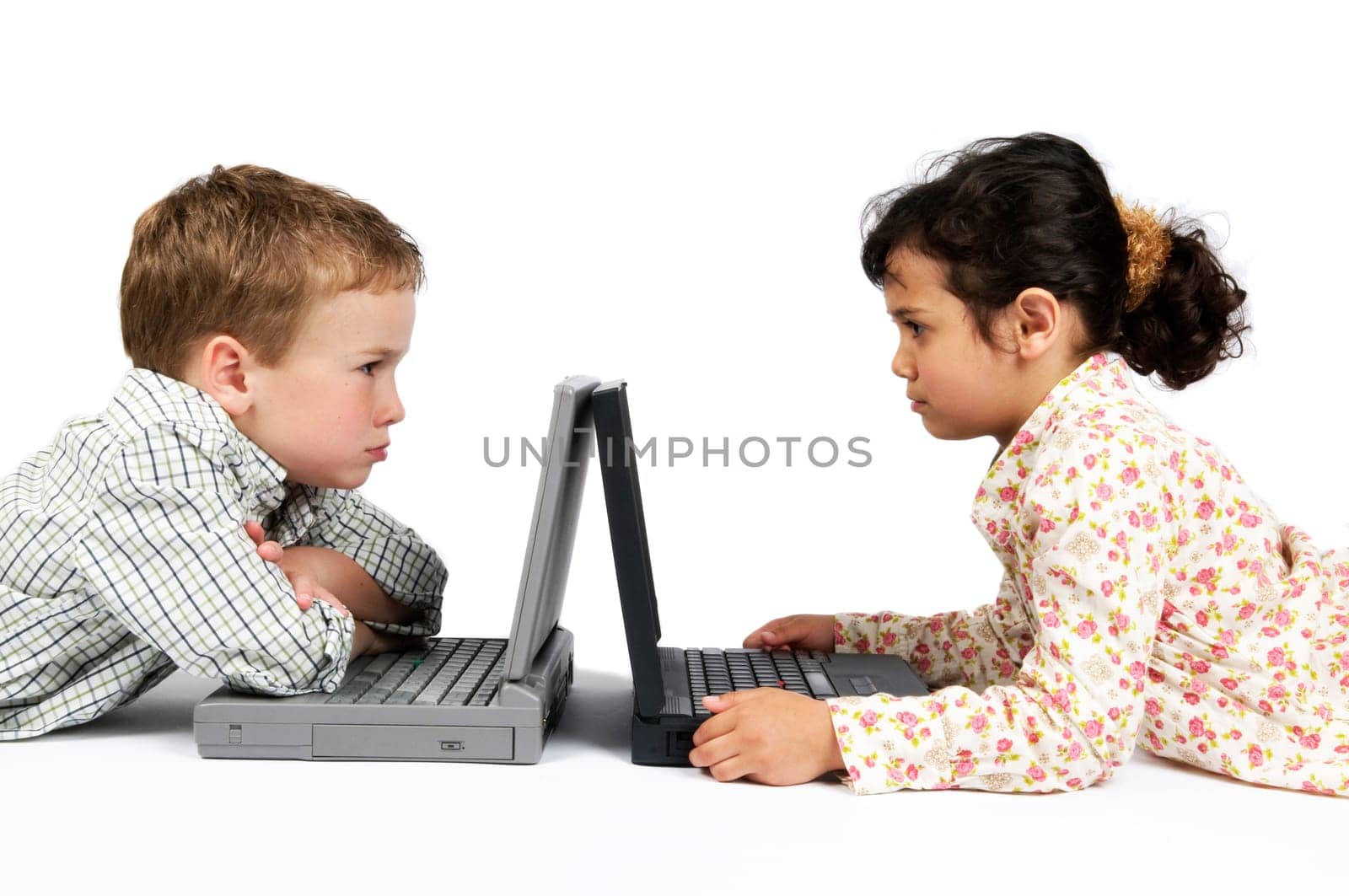 Two kids working on their laptop. Something made them angry...