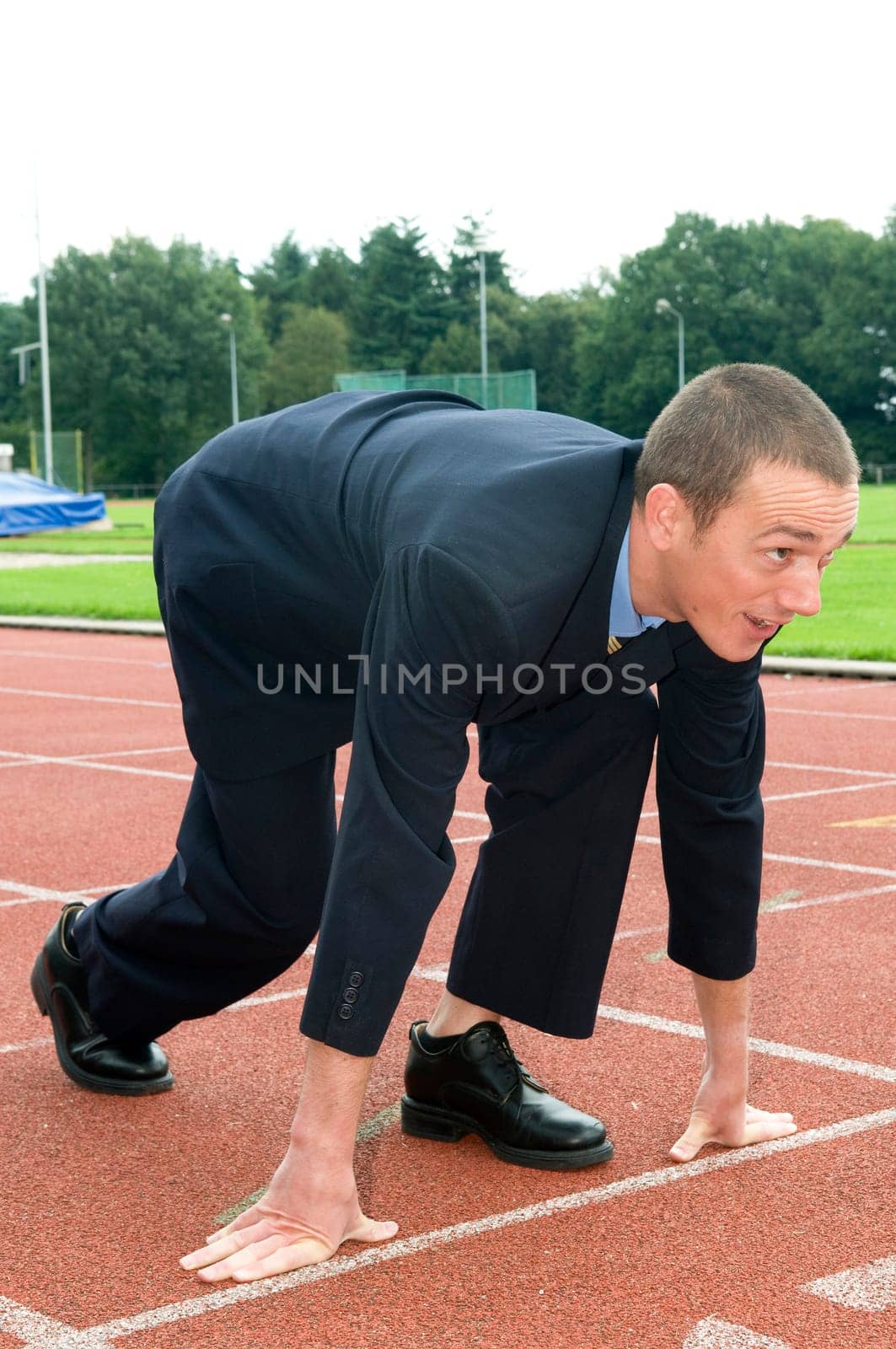 Businessman is ready for the start of his run.