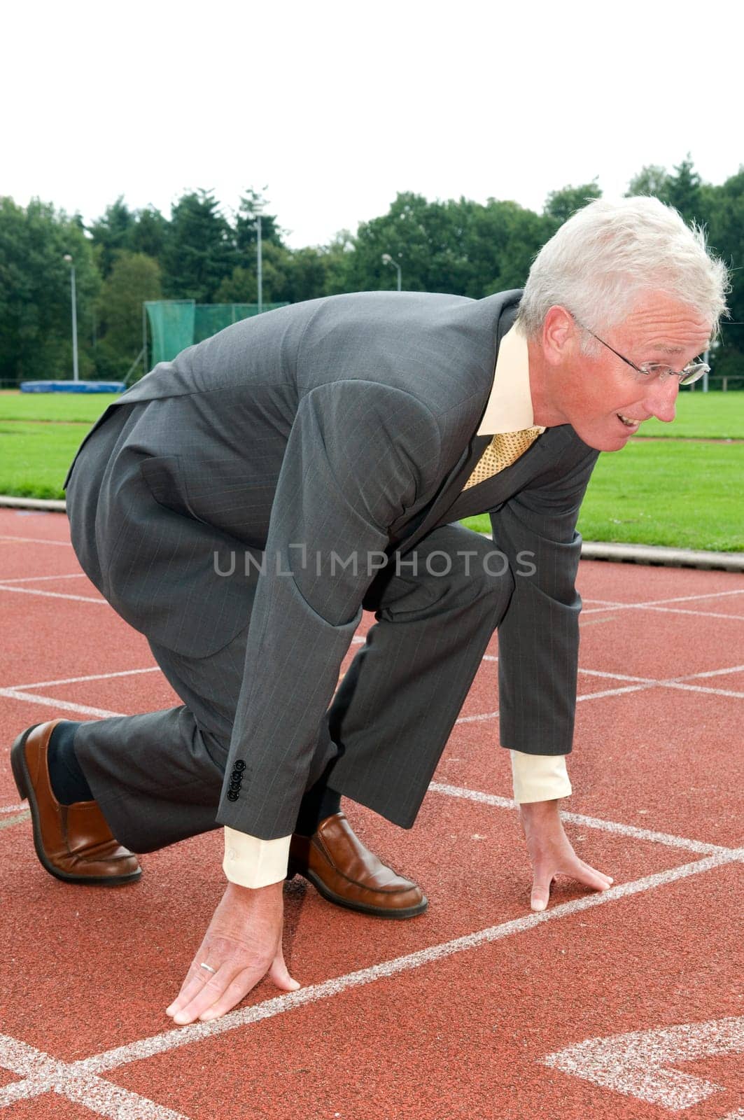 Businessman is ready for the start of his run.
