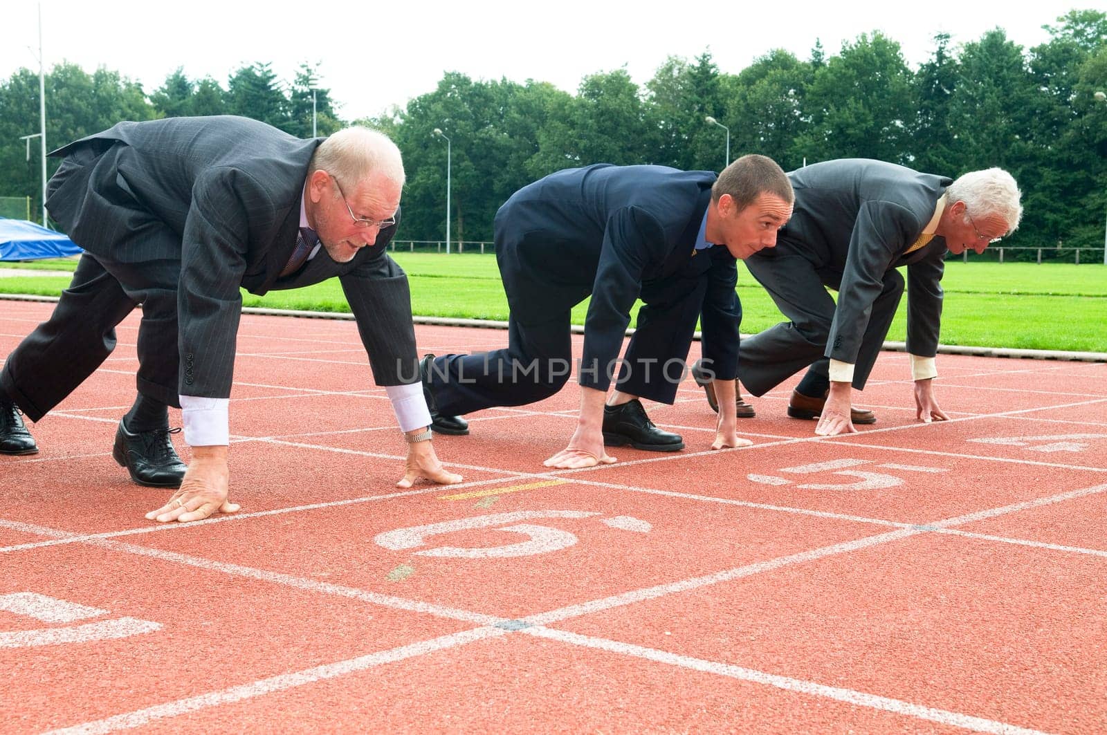 Group of businessmen are ready for the start of the run.