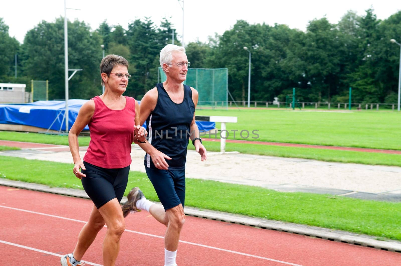 Two running pensioners having a healthy lifestyle.