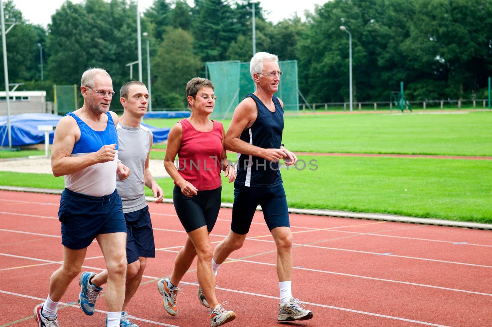 Group of running people on a race track