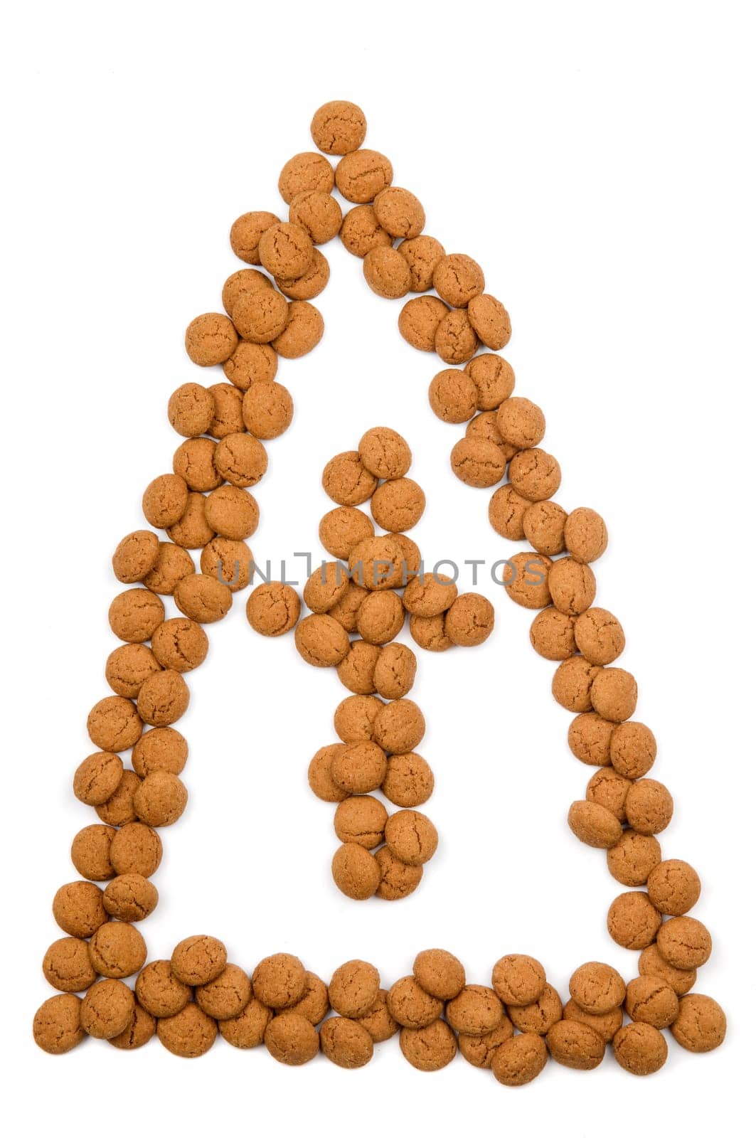 Little ginger nuts in the form of the mitre of Santa Claus. These little ginger nuts are used in Holland for the "Sinterklaas"" party, which is at Dec 5 every year. Sinterklaas is a sort of Santa Claus. In Holland these ginger nuts are called ""pepernoot"". Isolated on white."