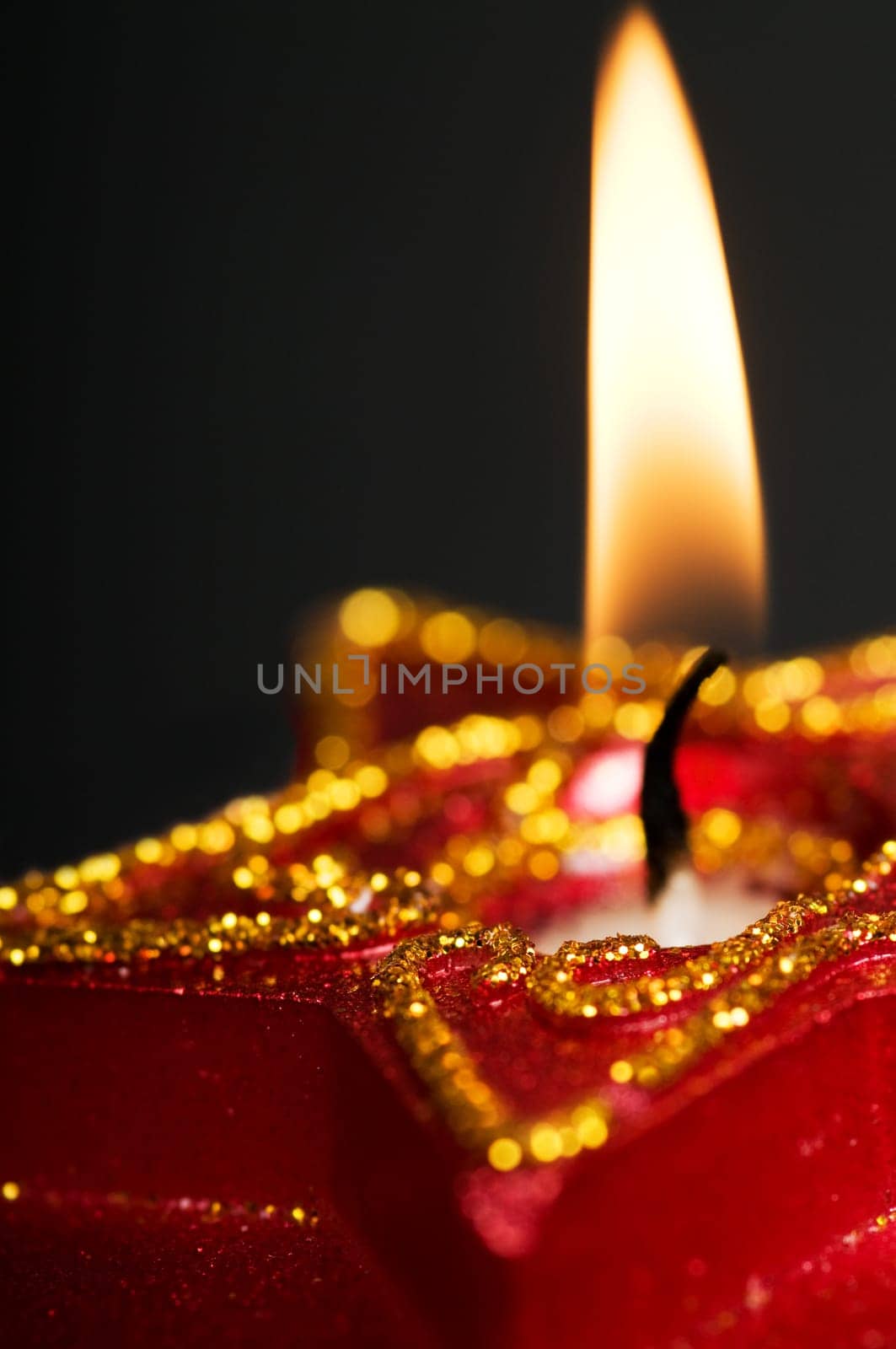 Christmas star with lightning candle. On a black background.