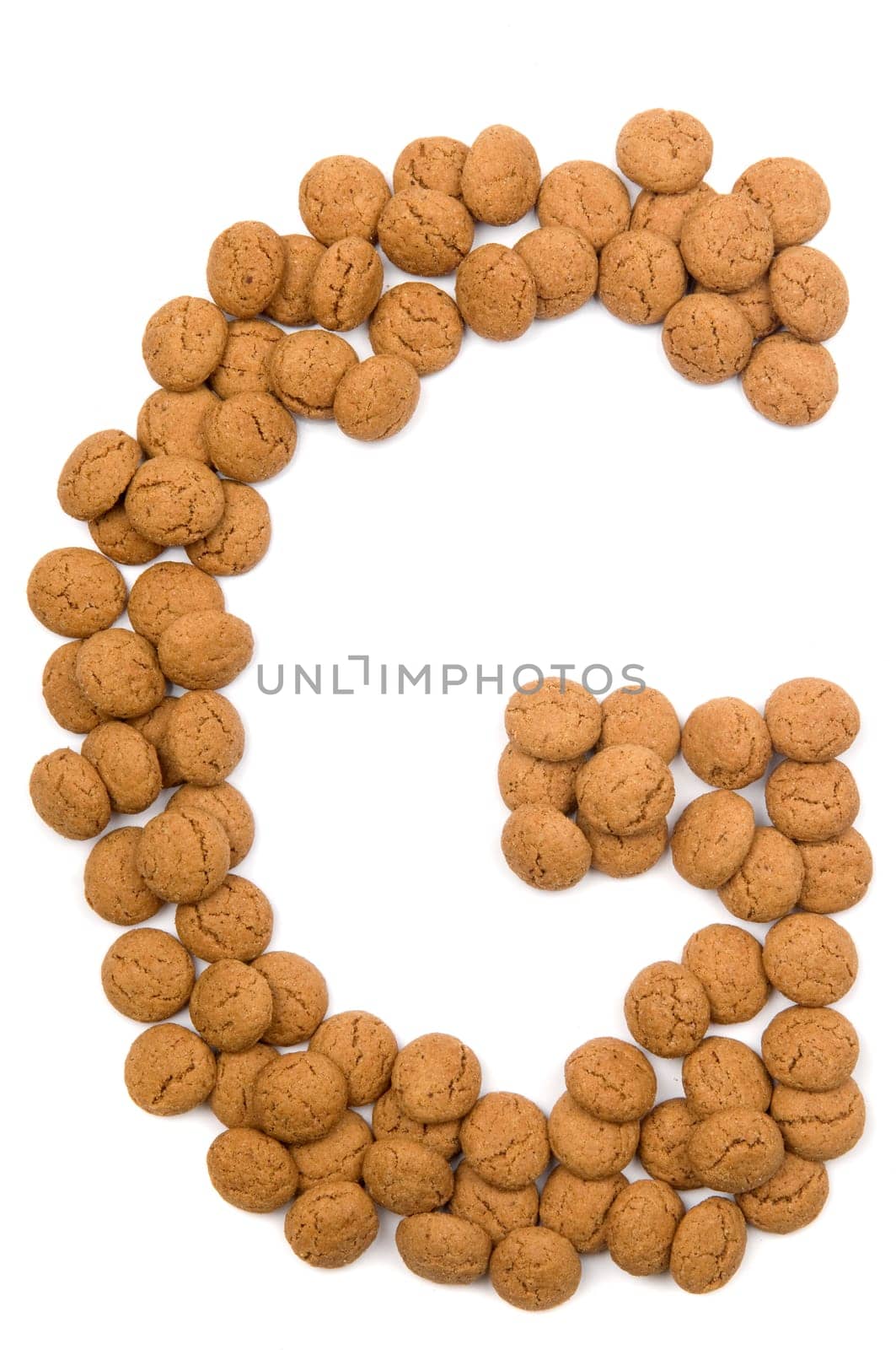 Little ginger nuts in the form of the letter G. These little ginger nuts are used in Holland for the "Sinterklaas"" party, which is at Dec 5 every year. Sinterklaas is a sort of Santa Claus. In Holland these ginger nuts are called ""pepernoot"". Isolated on white."