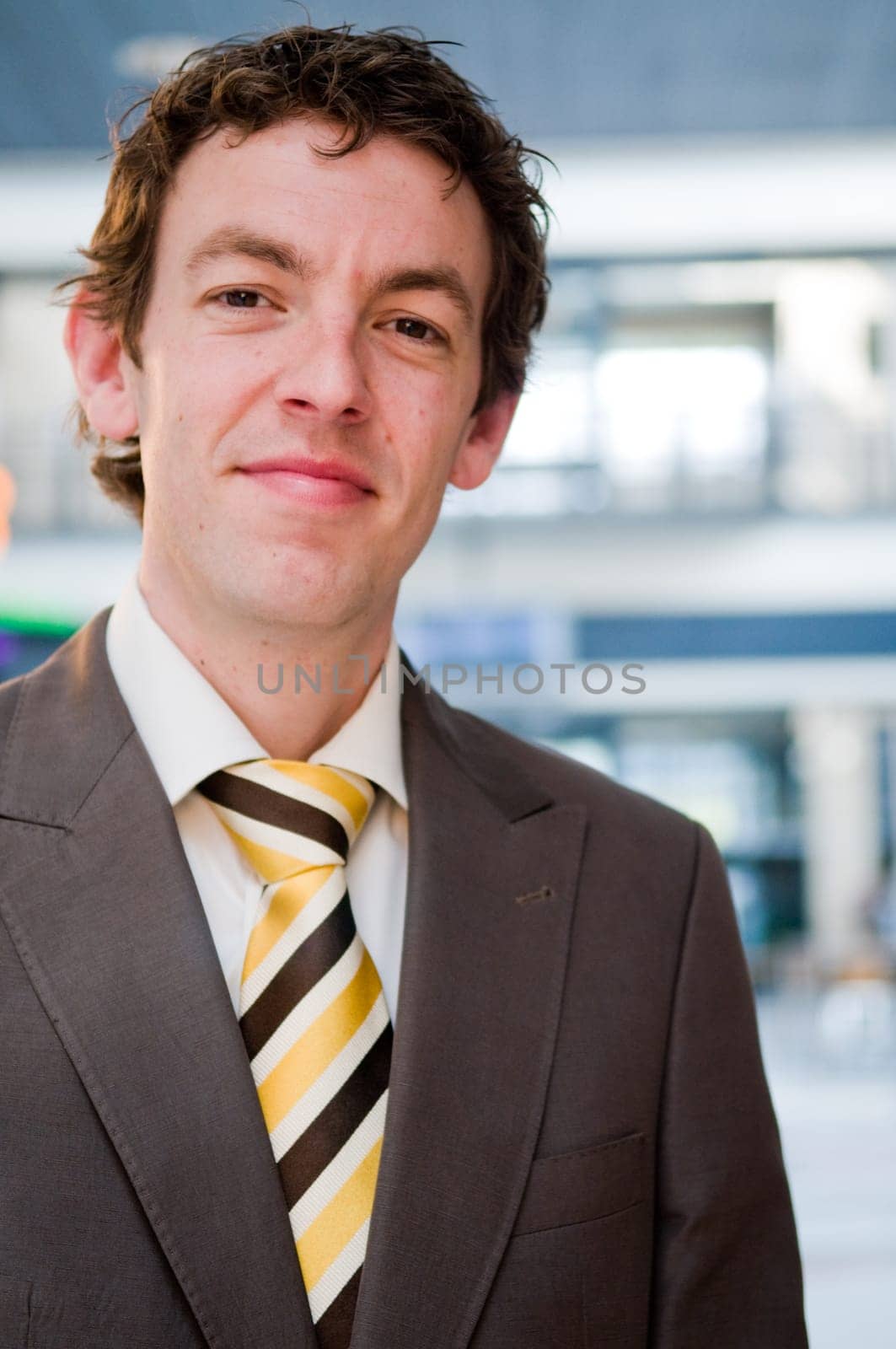 Happy young businessman in an office building.