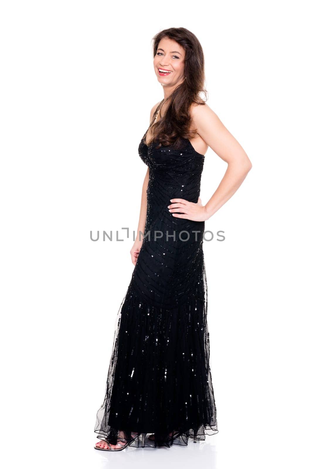 studio shot of a middle-aged in evening dress against white background