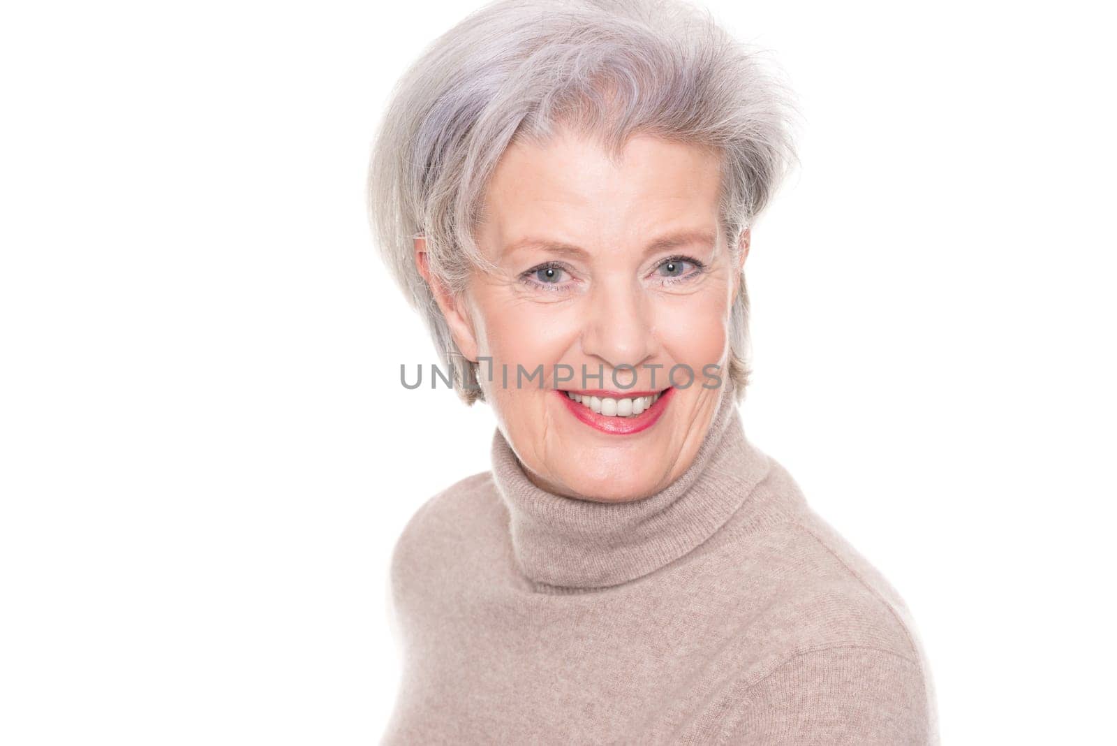 Studio recording of an active and happy senior against a white background
