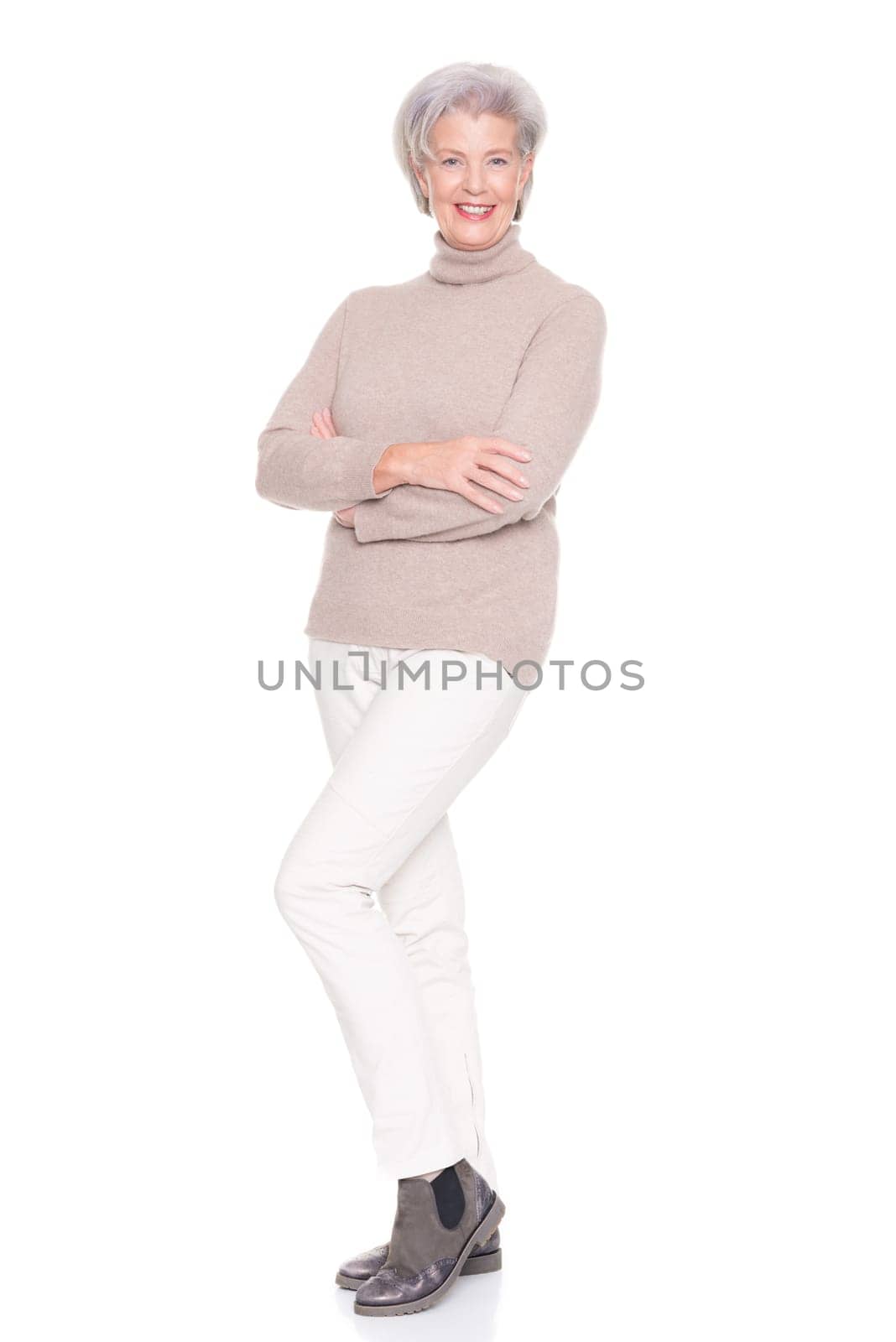 Studio recording of an active and happy senior against a white background