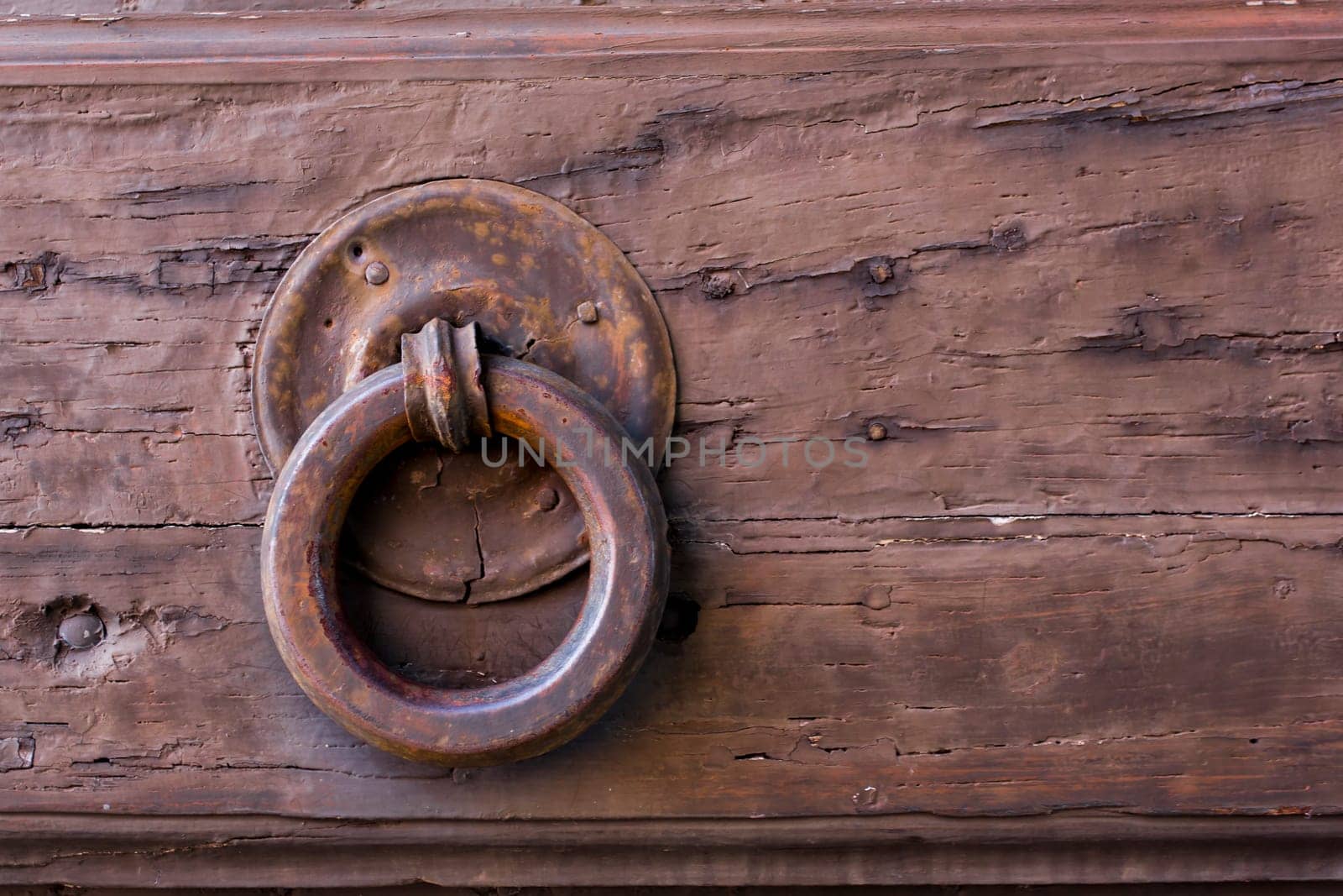 Close-up view of an ancient Tuscan iron knocker