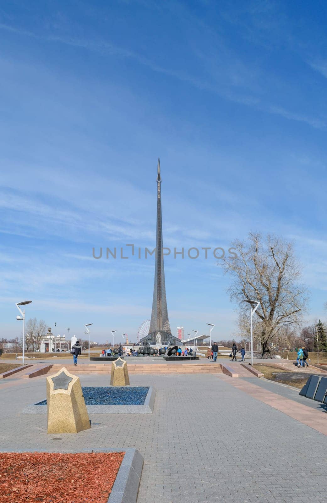 Moscow, Russia - March 29, 2016: Alley of Cosmonauts - memorial pedestrian street at the north of Moscow in front of the main entrance to The Exhibition of Achievements of National Economy (VDNH). At the end of the alley is a monument to Tsiolkovsky, followed by - the main monument "Conquerors of Space"""